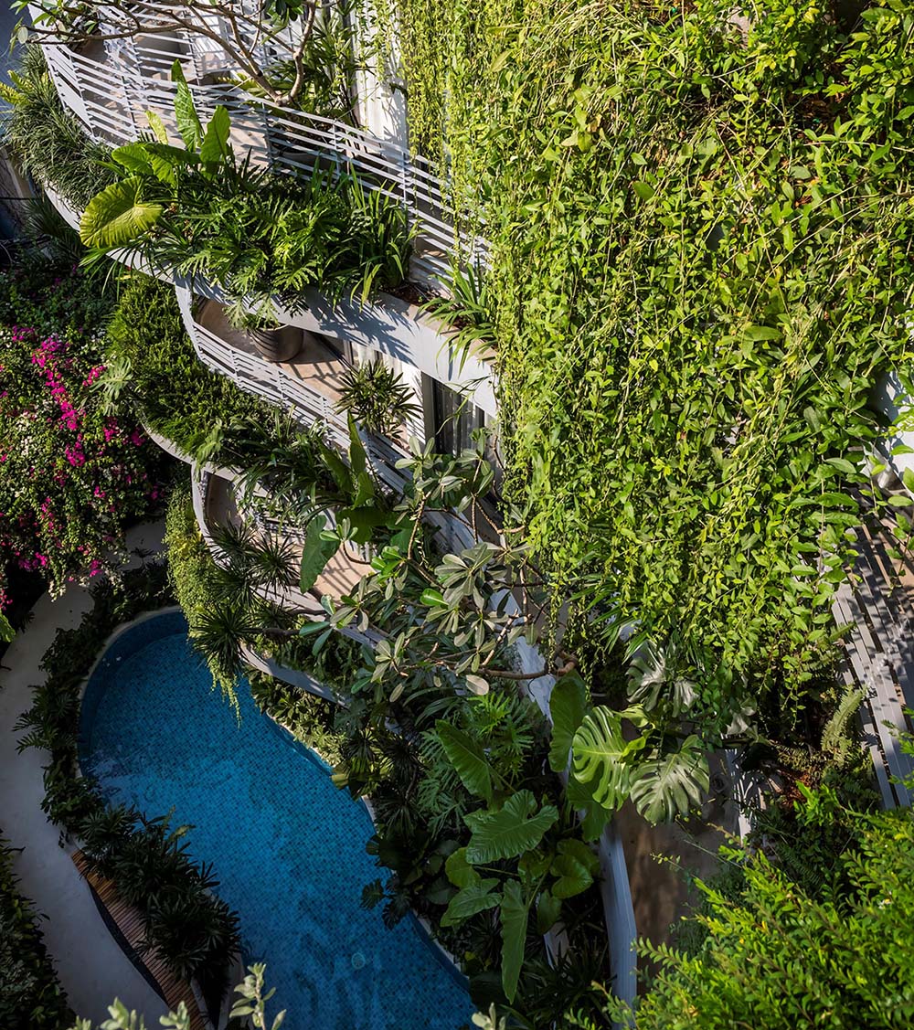 A curved swimming pool complements the curved balconies above.