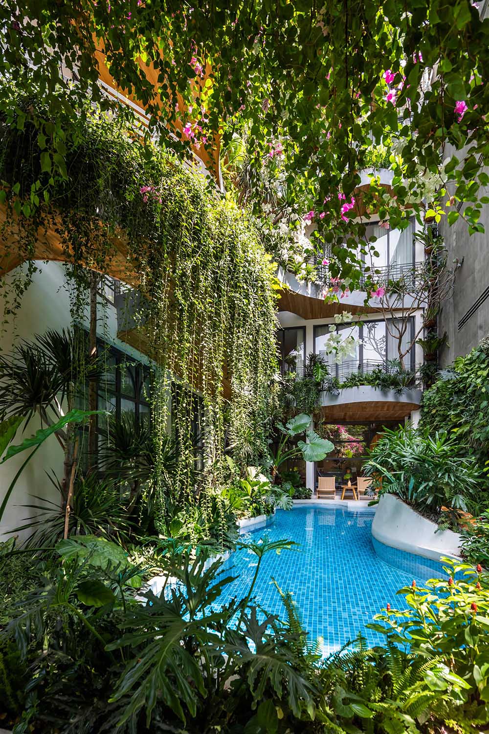 A curved swimming pool complements the curved balconies above.