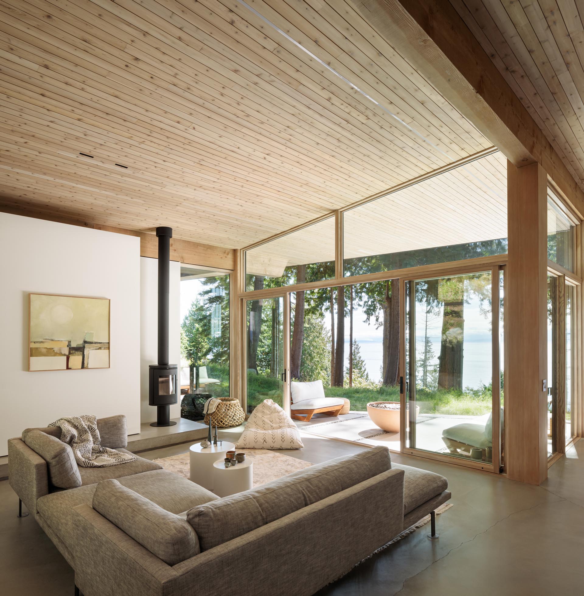 This modern living room has a simple gray sofa, while a black fireplace keeps the room warm at night.