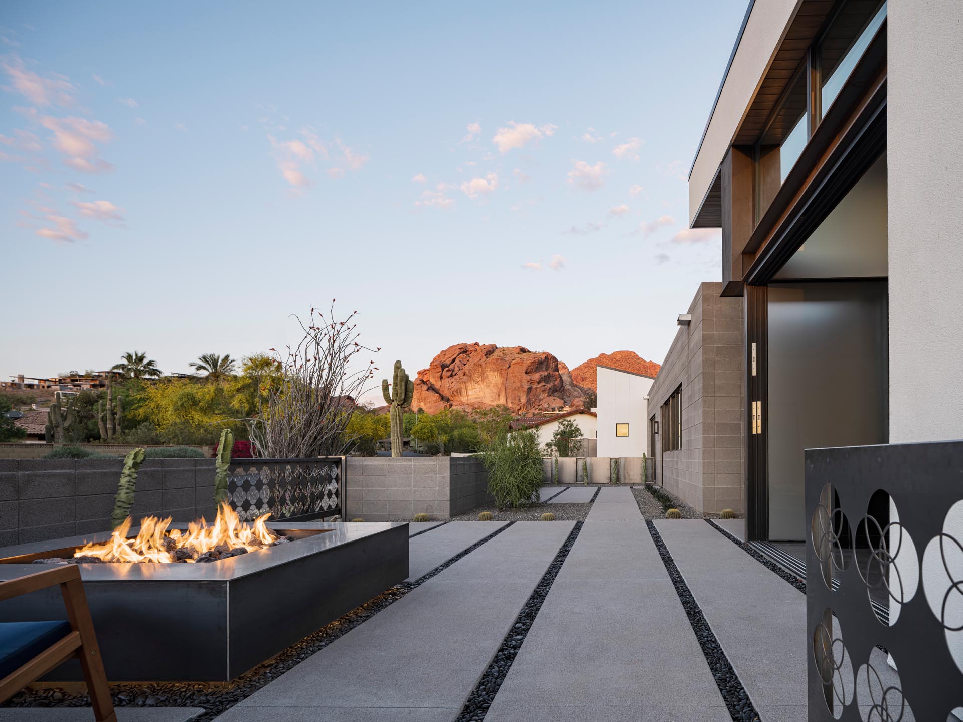 The semi-public front porch furnished with a fire pit and seating, projects out from the front of the house to take advantage of the mountain views.