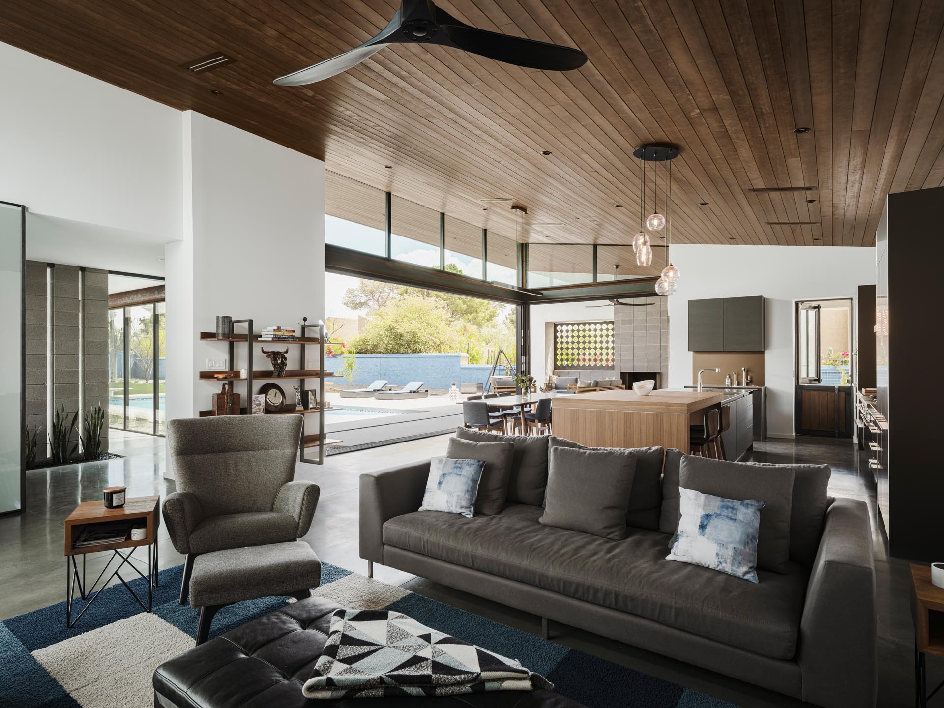A hemlock clad ceiling spans this great room, which involves the living room, kitchen, and dining room. The ceiling is tilted upwards to take in the views.