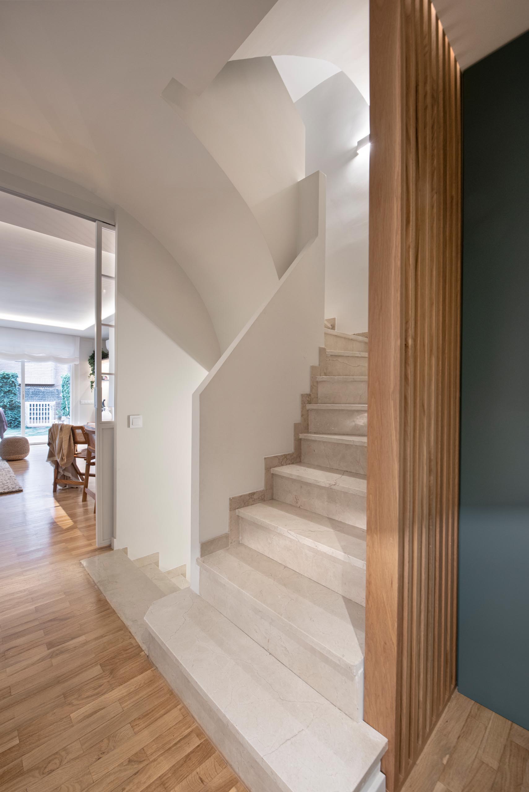 A semi-open staircase connects the various levels of this modern home.