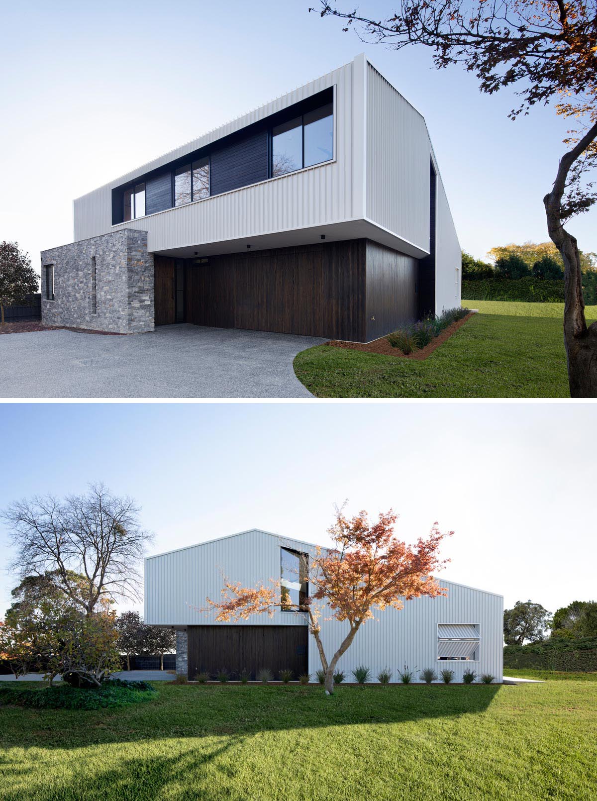 The exterior of this modern home features metal cladding with a white finish, black window frames, dark wood accents, and drystone stacked walls.