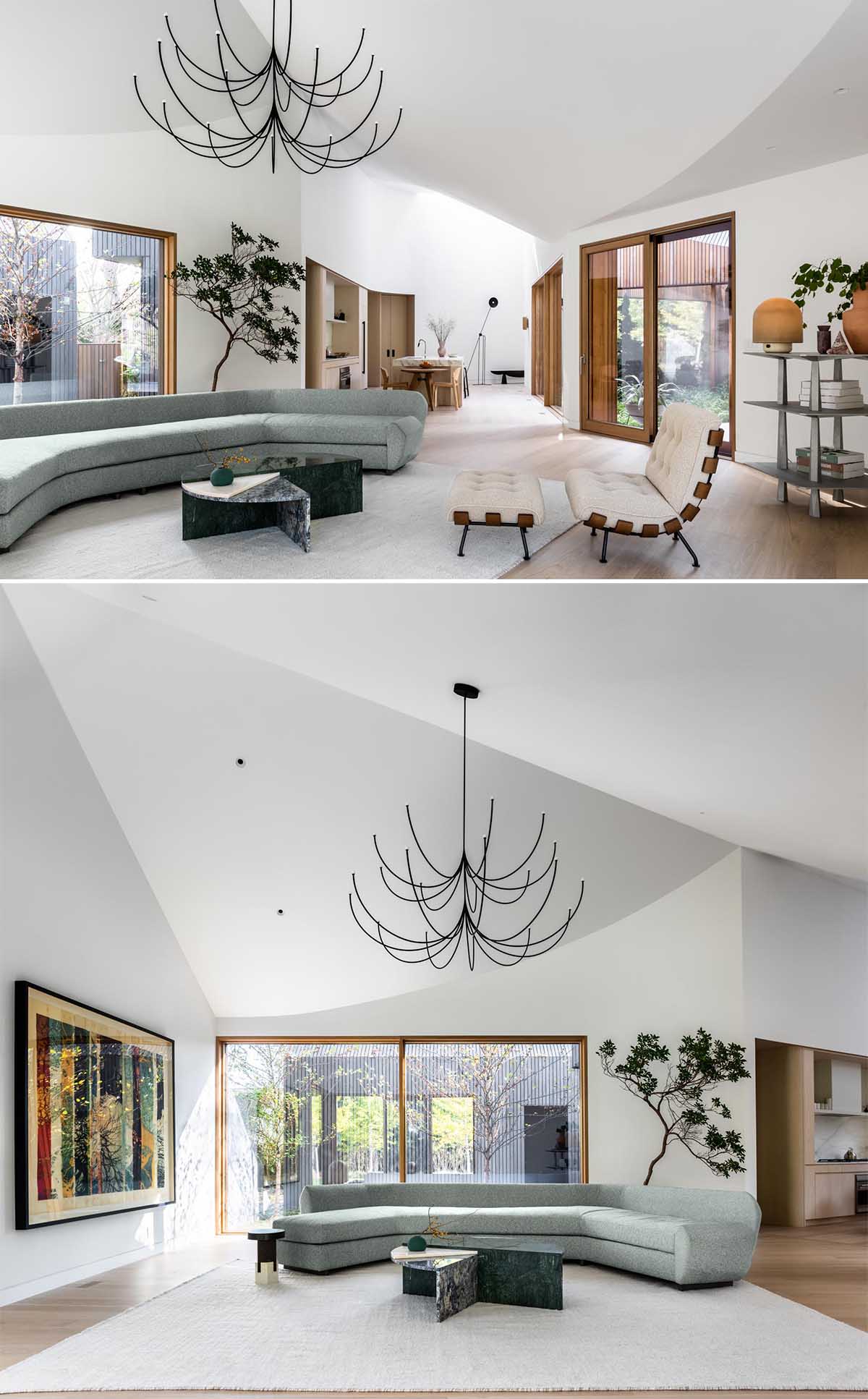 A bright white interior contrasts the exterior of the home, and creates a feeling of openness, which is also accentuated by the angled ceilings, that can be found in both the living room and kitchen.