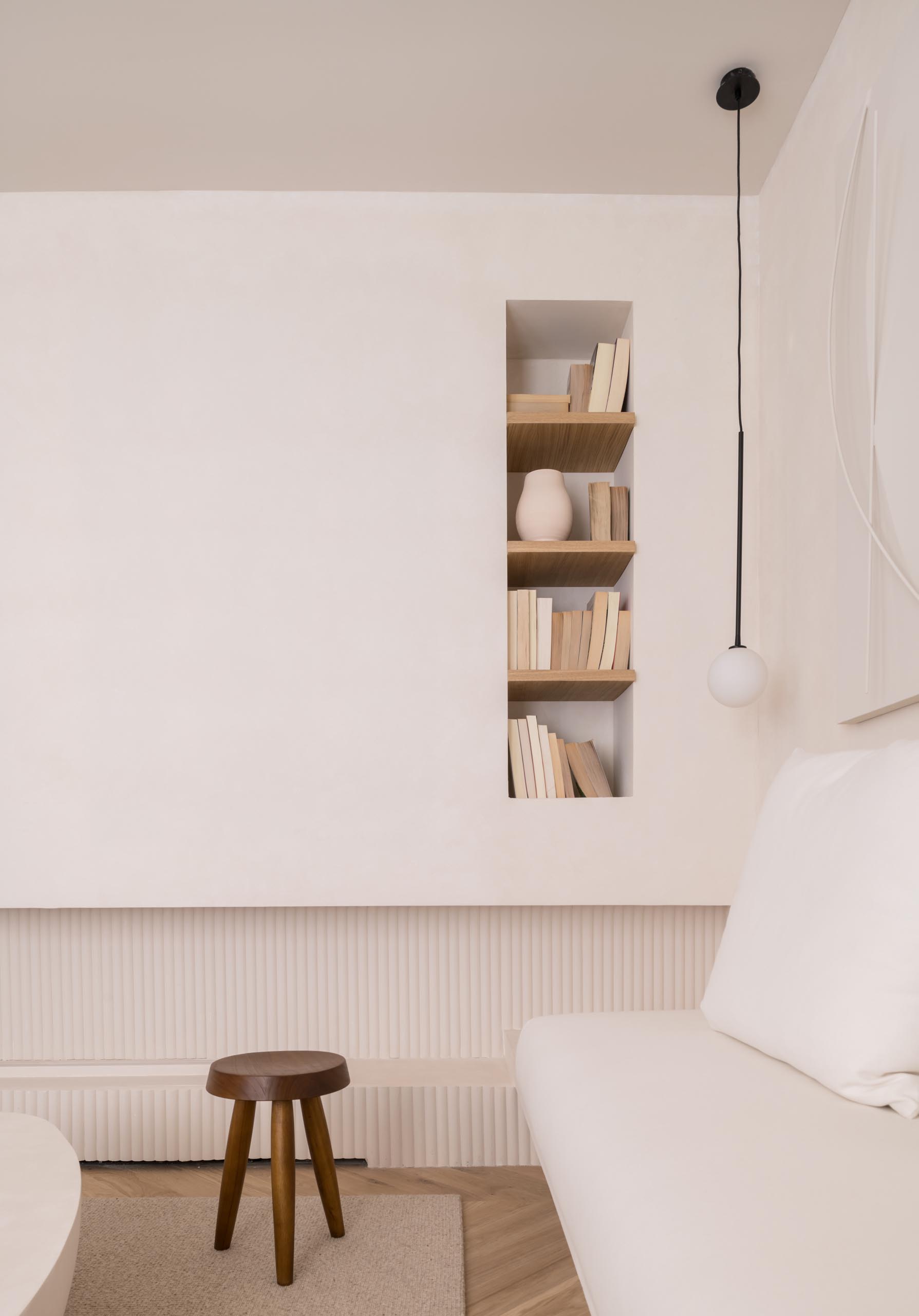 A built-in bookshelf with wood shelves.