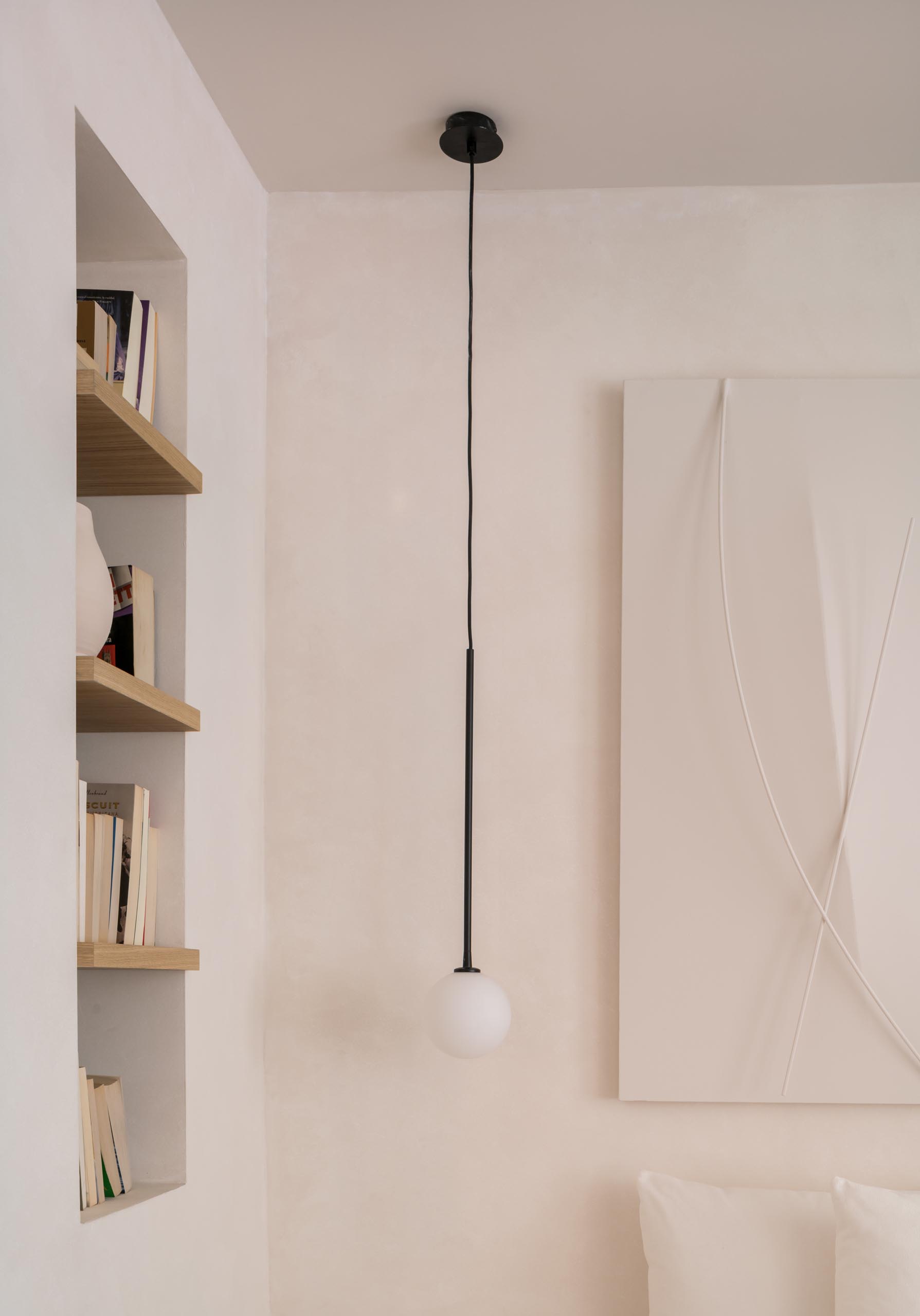 A recessed nook with built-in wood shelves.