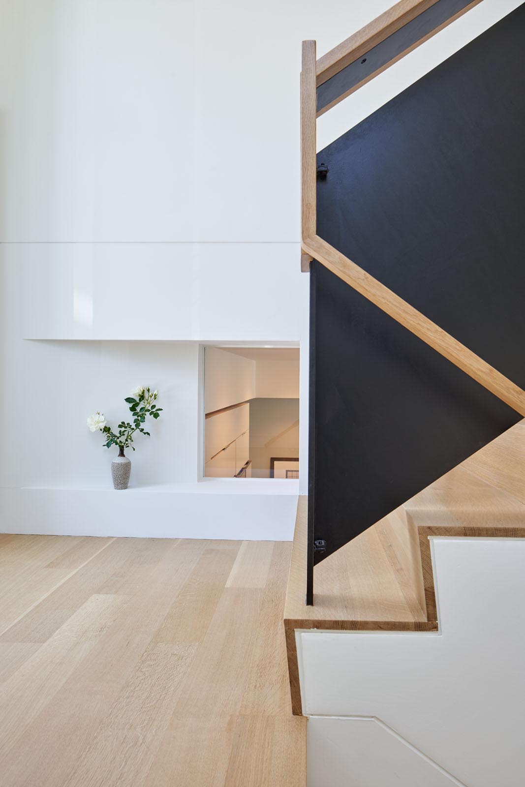 The wood stairs of a modern split-level home.