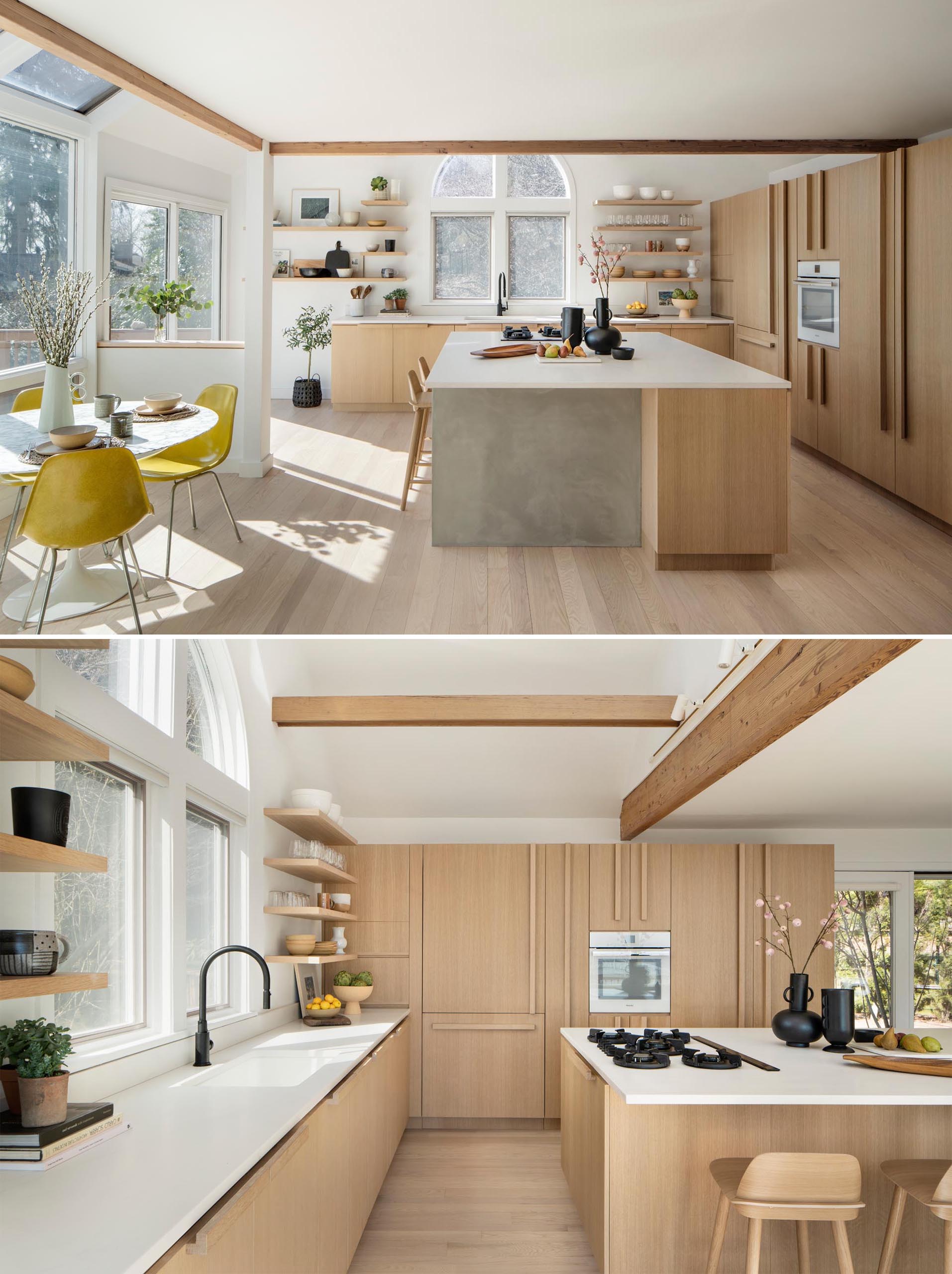 A remodeled kitchen with water-based white rift oak for the cabinets, a large island, and quartz countertops.