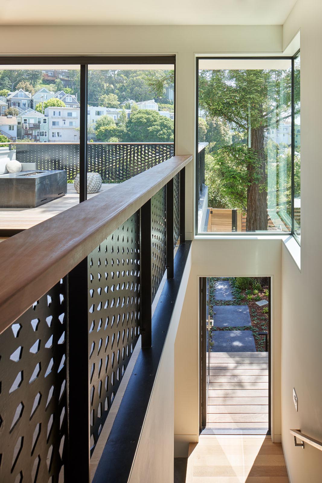 A metal guardrail inspired by the huge conifer tree outside and its pine cones.