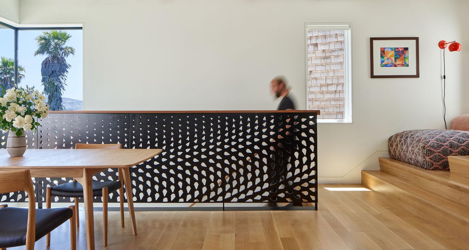 A metal guardrail inspired by the huge conifer tree outside and its pine cones.