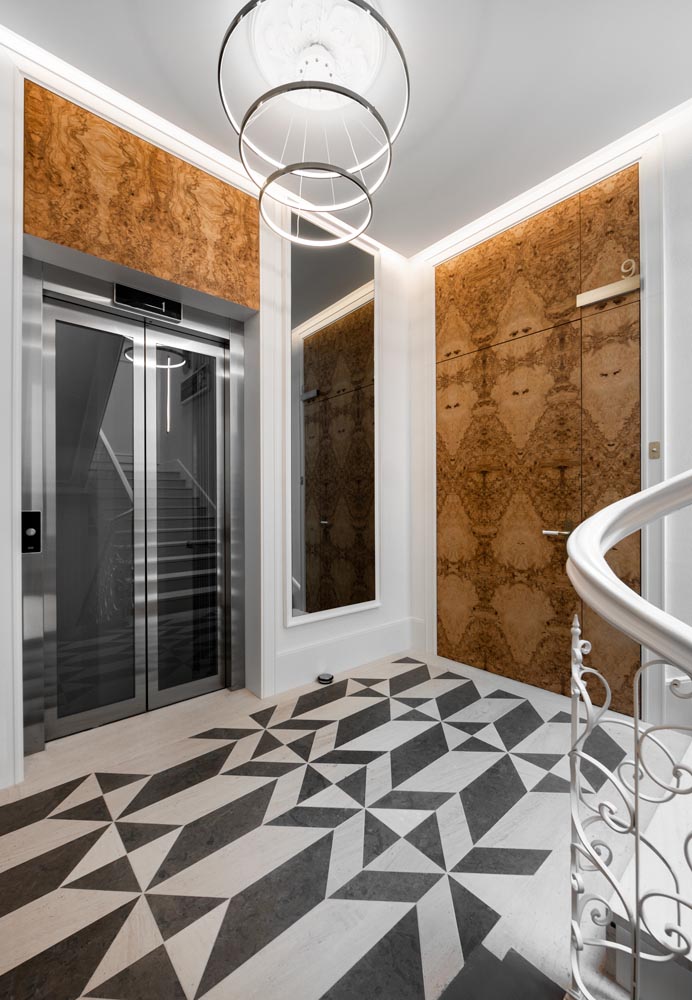 Bold patterned floors create eye-catching black and white elements throughout an apartment building.