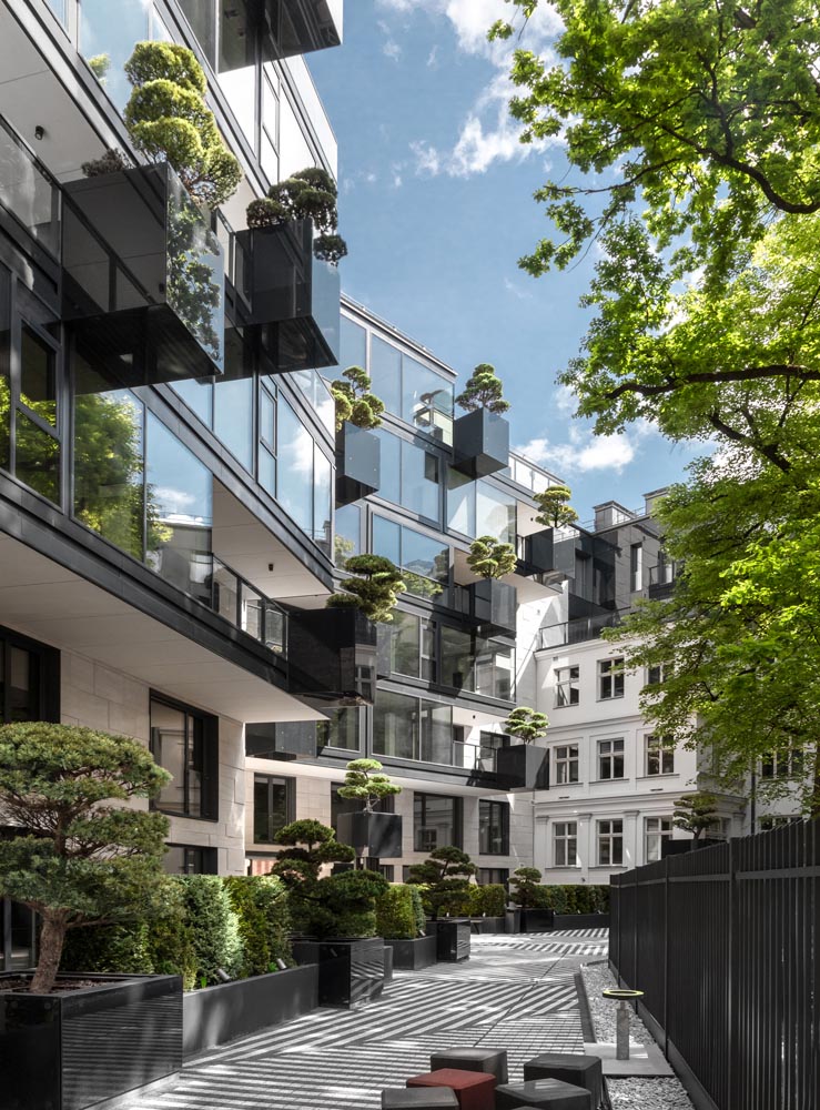 As part of the design of the new facade of this apartment building, ‘flying’ conifers and bonsai trees were placed in cantilevered planters.