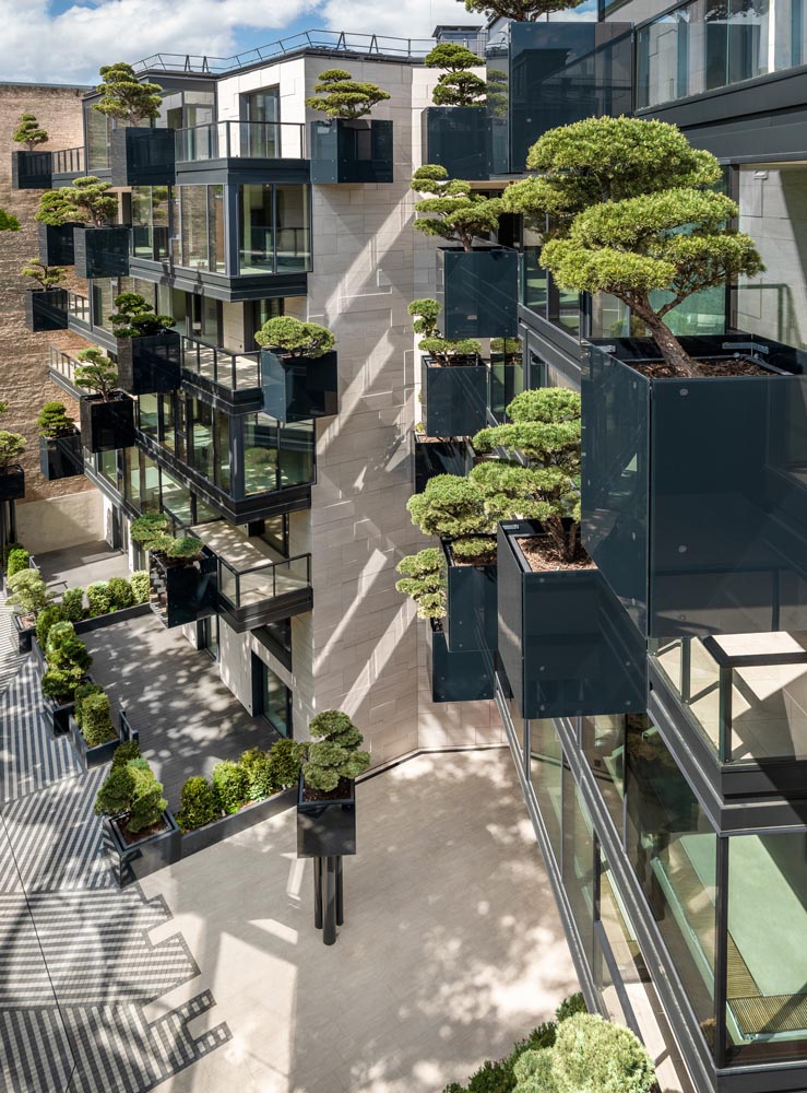 As part of the design of the new exterior of this apartment building, ‘flying’ conifers and bonsai trees were placed in cantilevered planters.