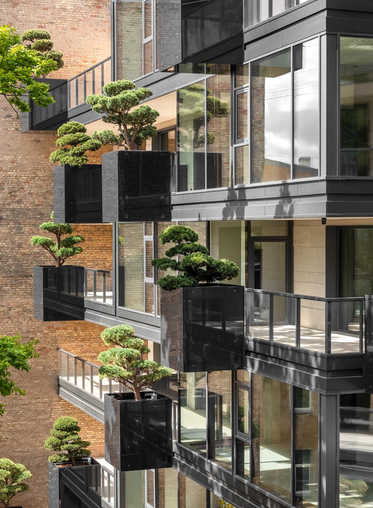 As part of the design of the new exterior of this apartment building, ‘flying’ conifers and bonsai trees were placed in cantilevered planters.