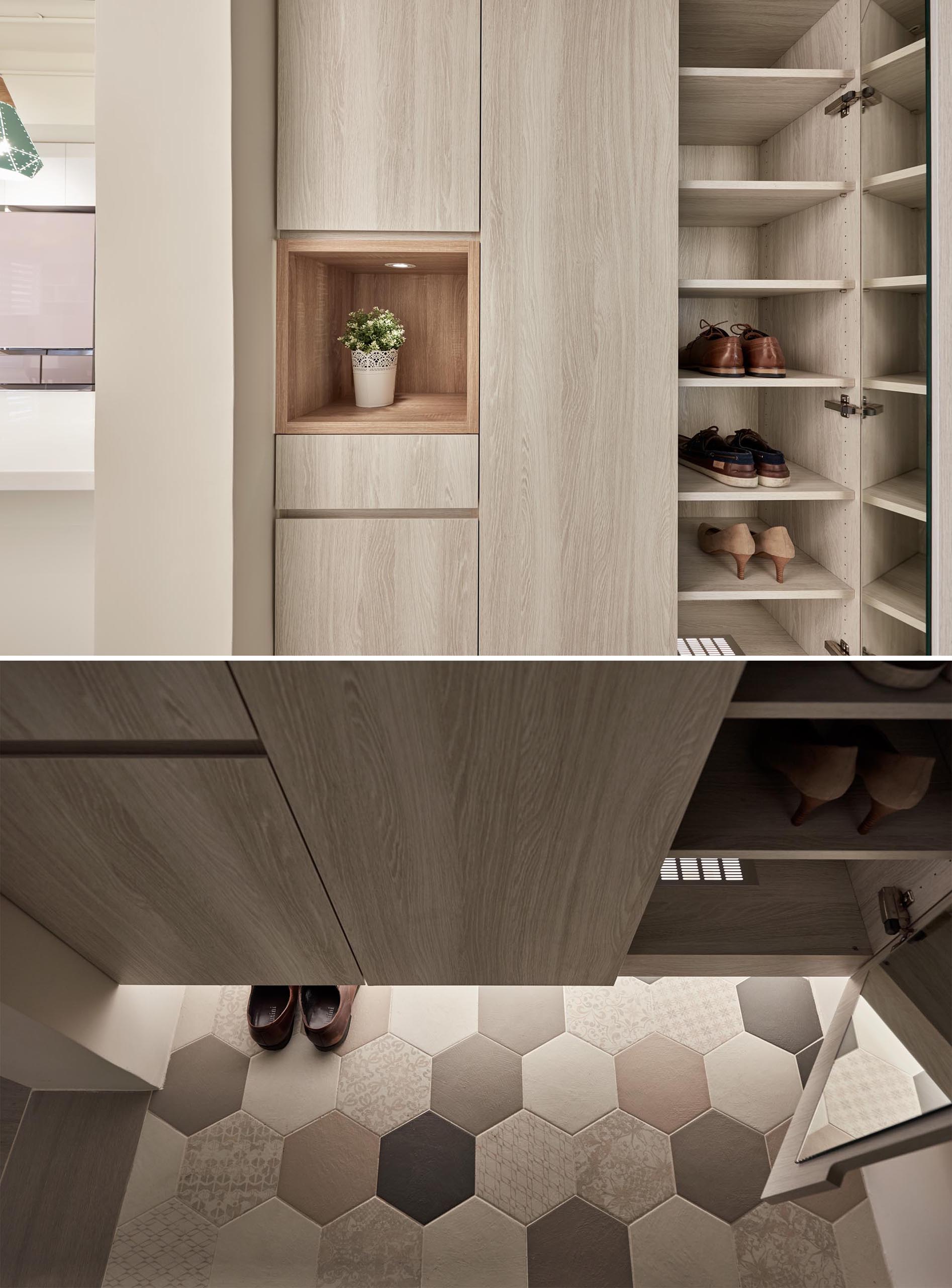 The entryway has tall storage closets that float above a tiled floor, that's highlighted with the use of hidden LED lights. A small open shelf with a light is an ideal place for keys and wallets.