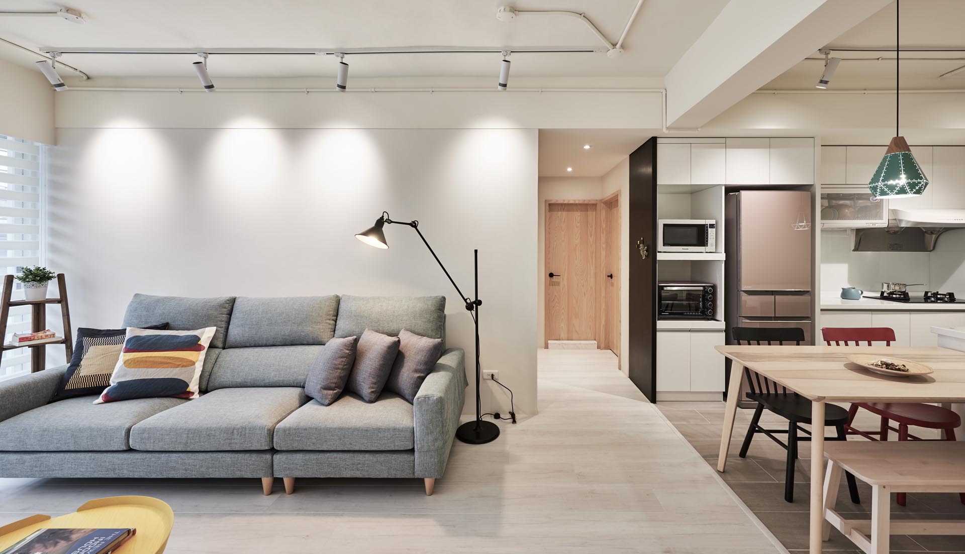 A small hallway between the living room and the kitchen leads to the bedroom and bathroom.