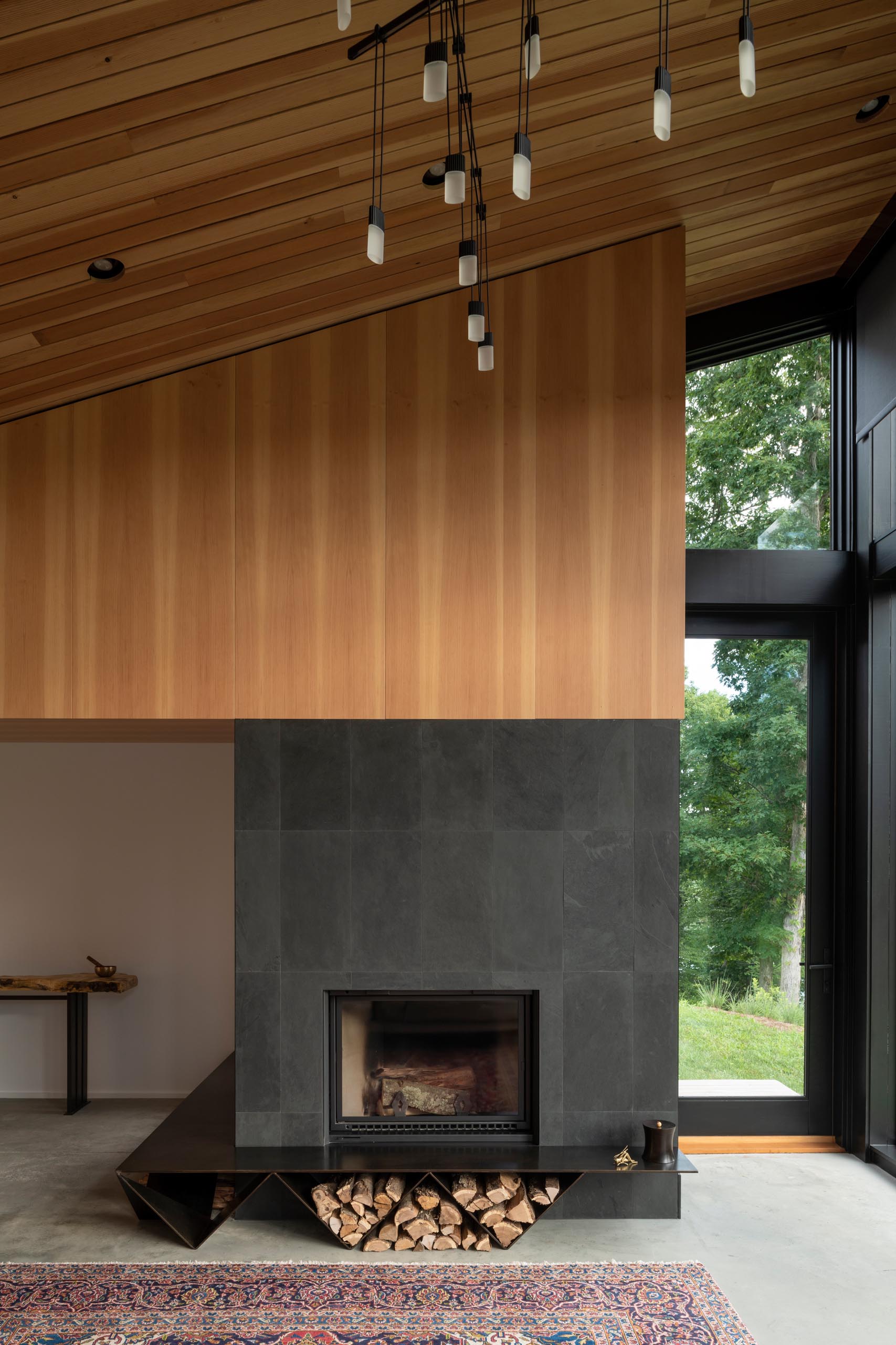 A modern fireplace with a charcoal surround and black fireplace.