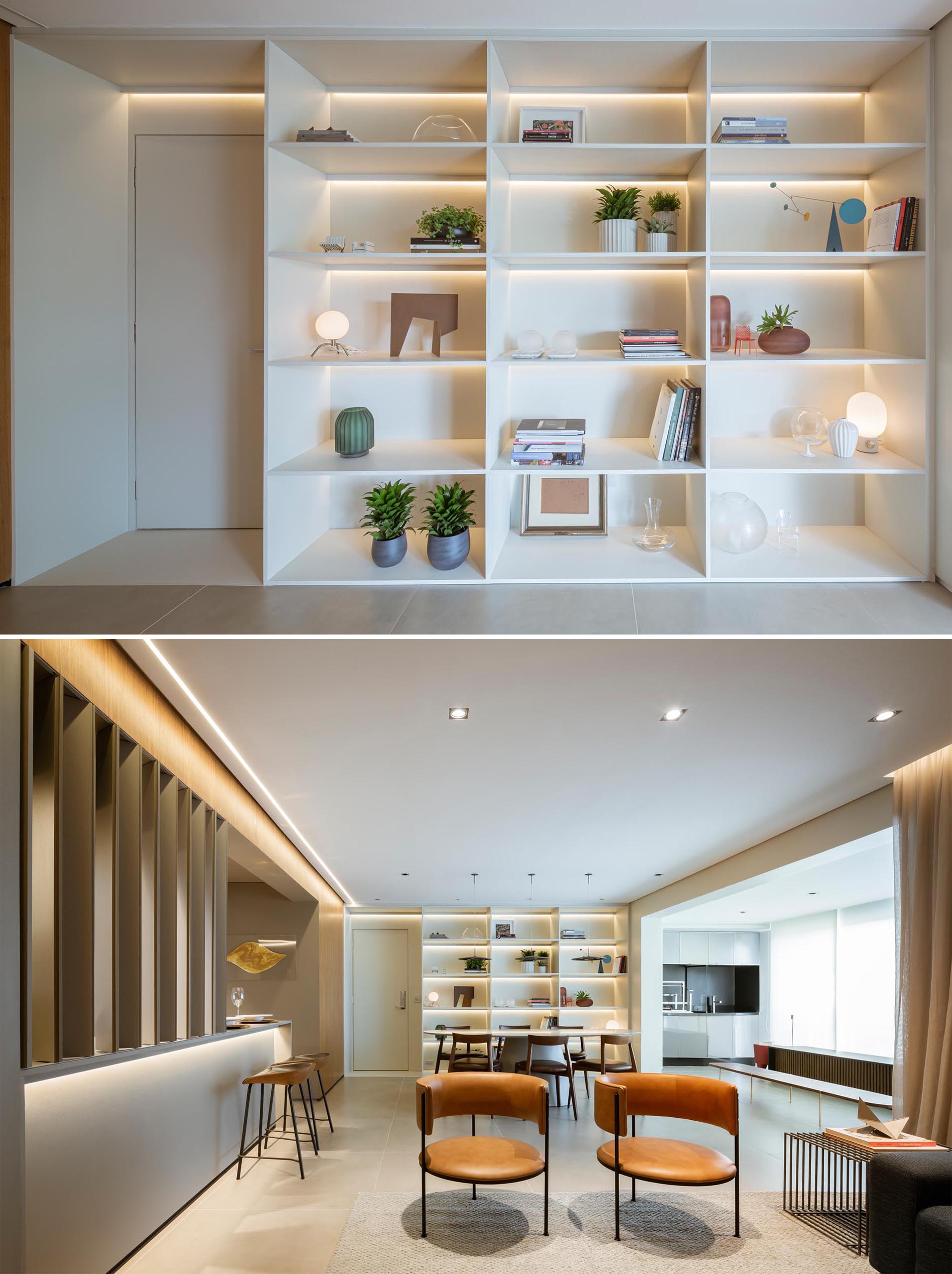 A floor-to-ceiling white shelving unit that includes hidden LED lighting.