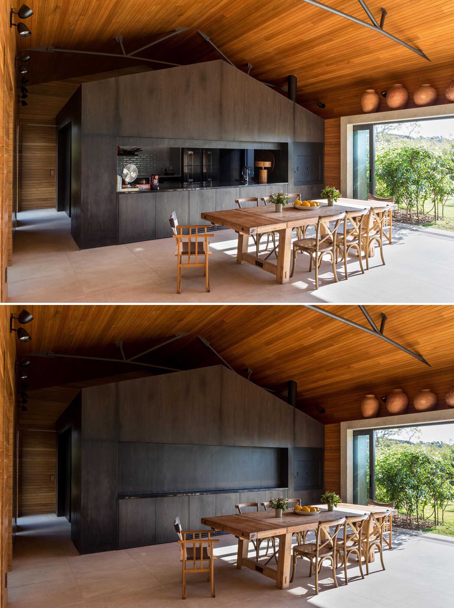 The interior of this modern home is lined in Tauari, a Brazilian pale wood, while the kitchen is completely made out of darkened wood. The kitchen can also be hidden from view, as a section of the cabinetry can be lowered down to close it off.