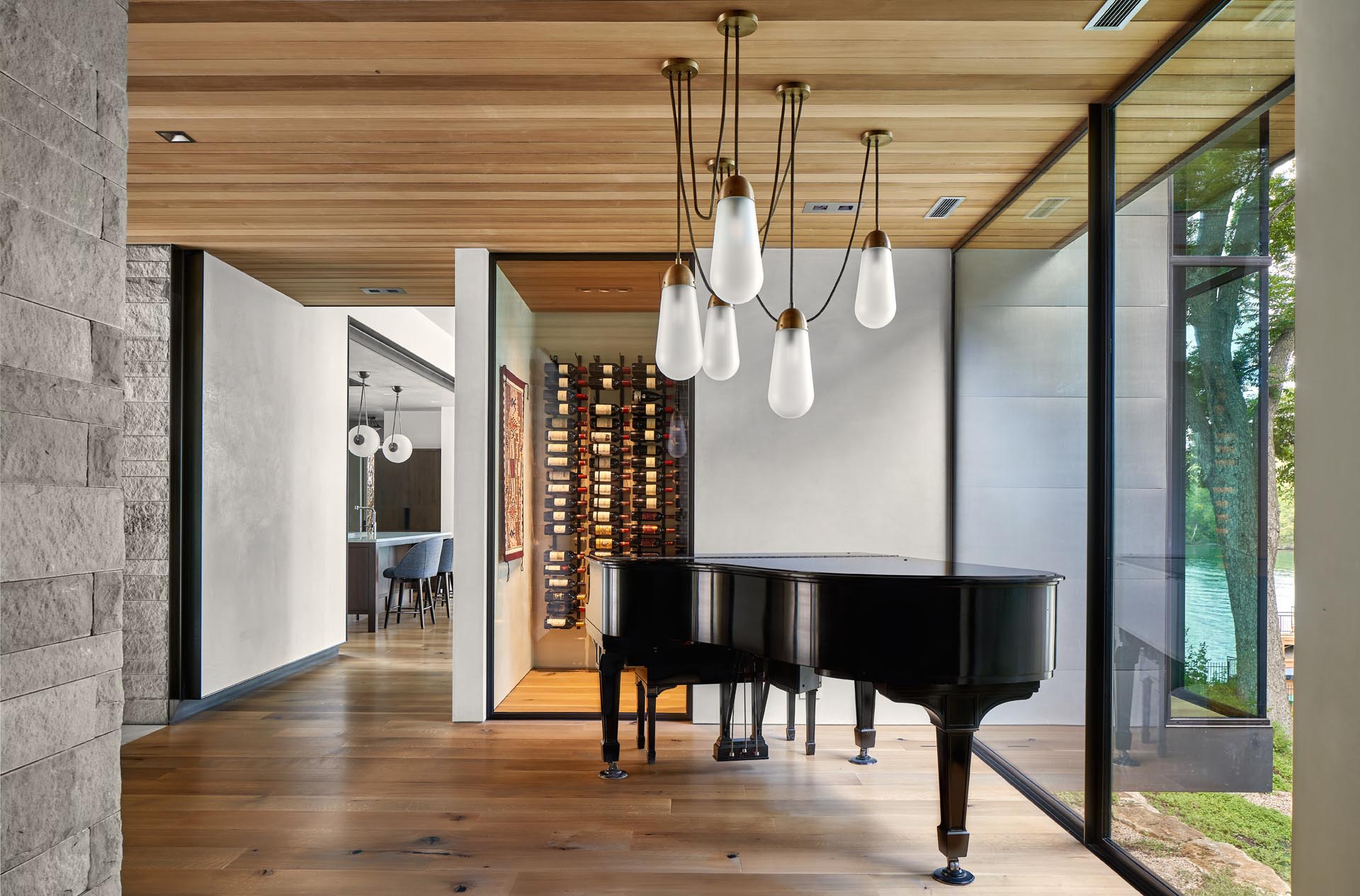 This modern home has a wine cellar and an entryway, which is furnished with a Steinway grand piano and custom Apparatus lighting.