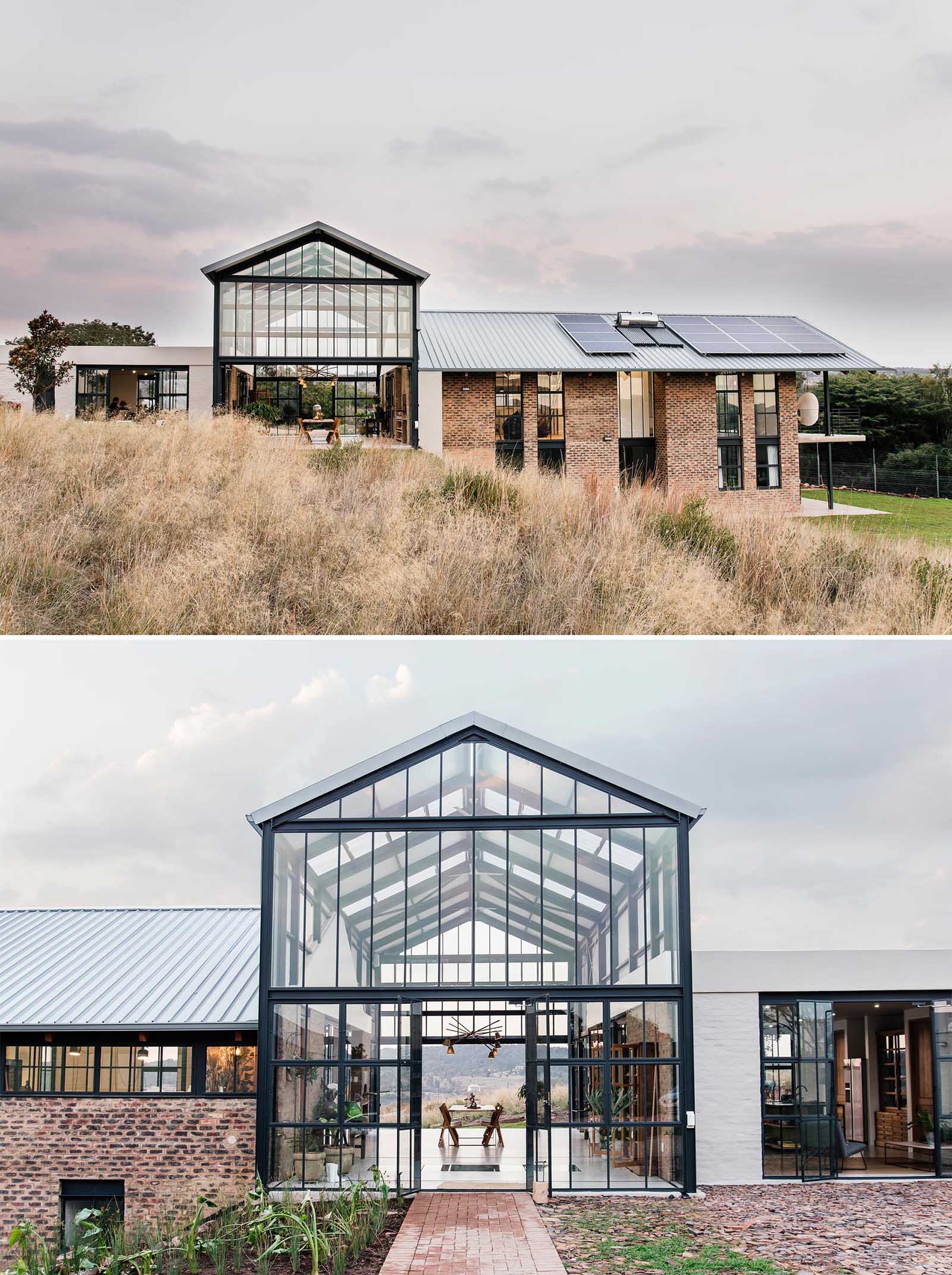 The double-height conservatory can be opened, providing uninterrupted views of the landscape, while a glass section flooring gives a glimpse of the lower level below.