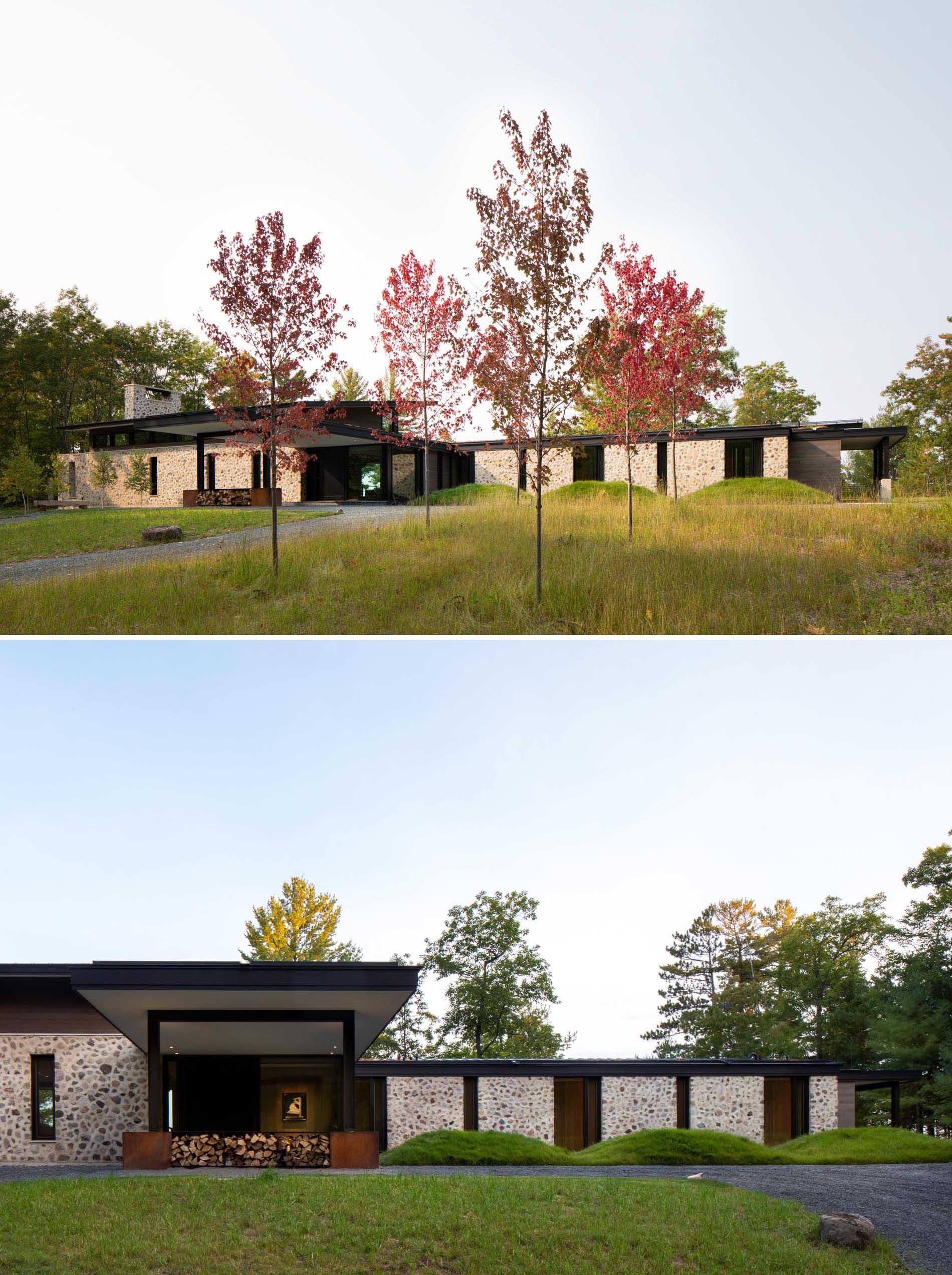 Rough-cut fieldstone set in thick, hand-troweled mortar stretches across this modern homes exterior’s south facade and connects with the interior two-story central fireplace.