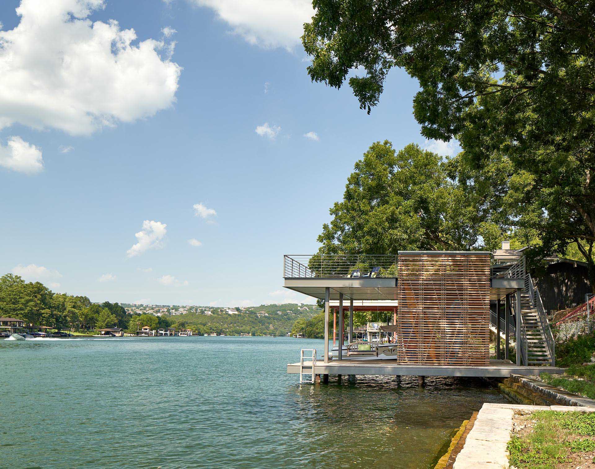 A two level boat dock provides an outdoor lounge space perched above the water.