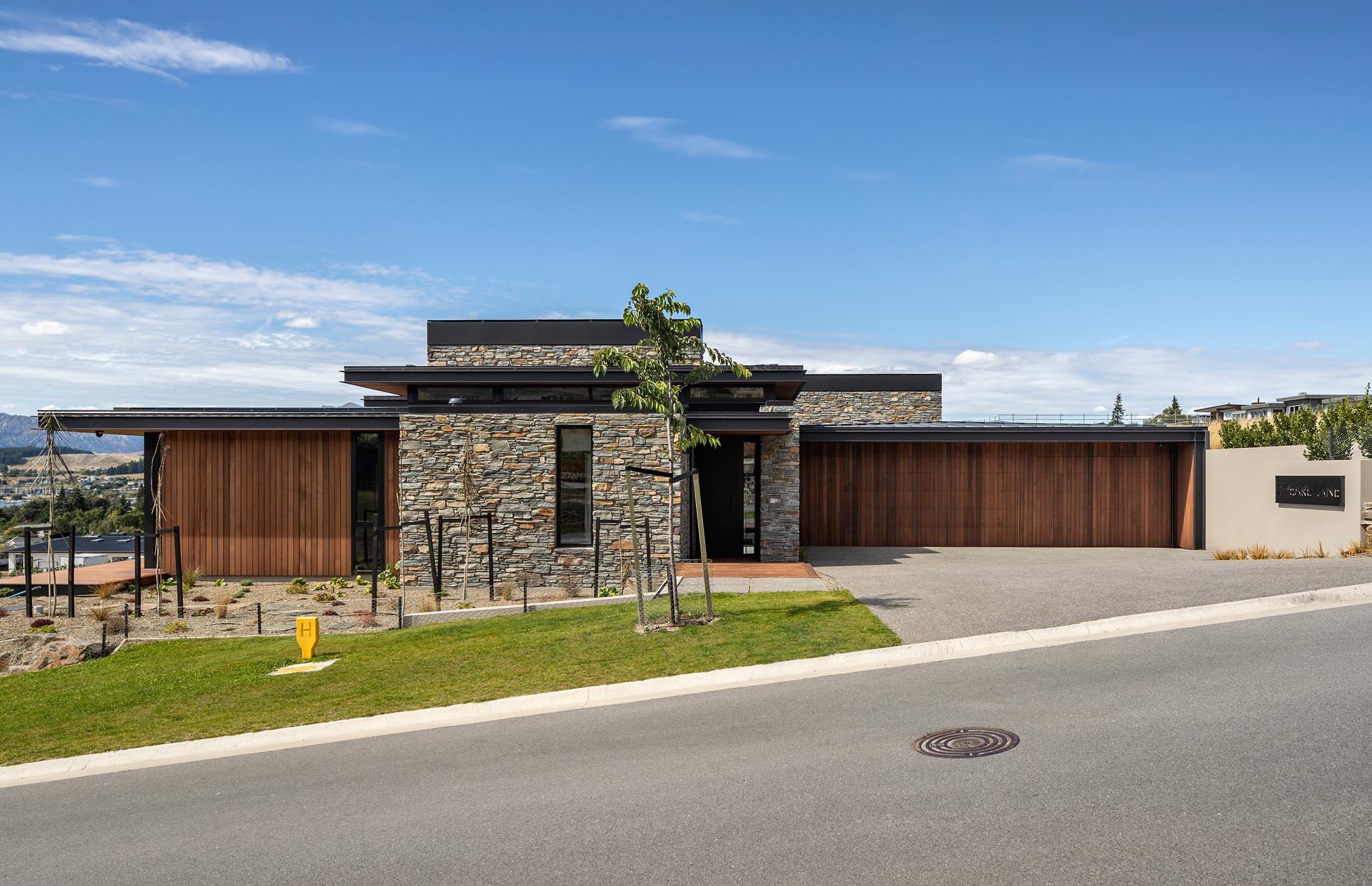 Using a palette of schist, metals and cedar, with exposed structural steel fascias to add a touch of grit, this modern house appears in keeping with the alpine and rural landscapes of the area.