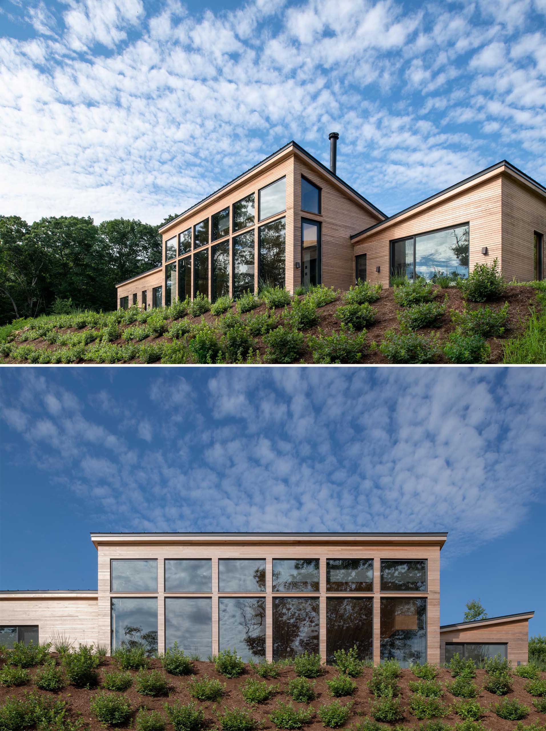 A modern house with wood siding and charcoal colored accents, like window frames, metal roof, and garage door.