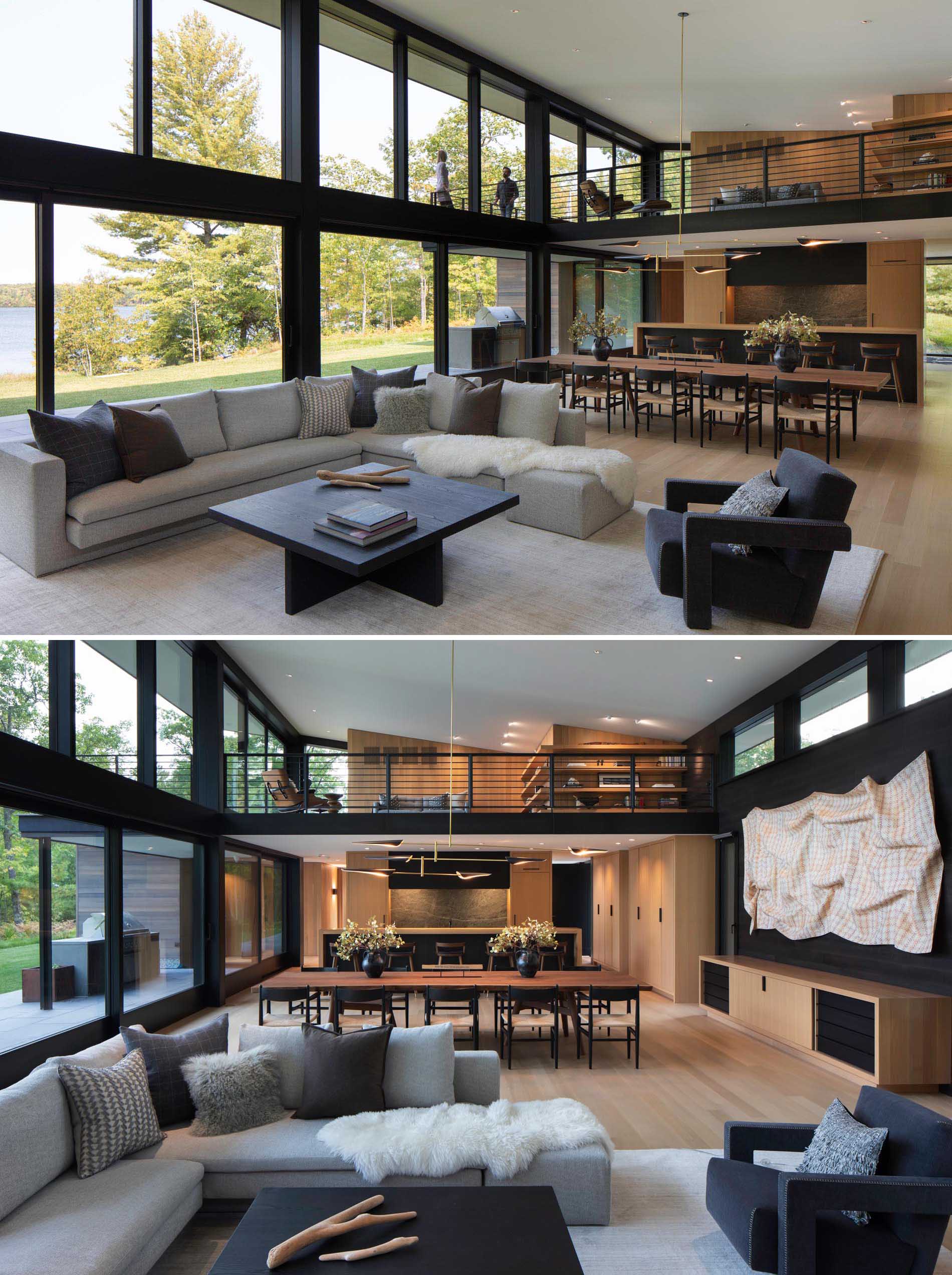 This living room, furnished with an L-shaped gray couch, has a wall of windows and glass doors, with the doors providing access to the patio and outdoor kitchen. There's also a view of the loft which opens up to a balcony.