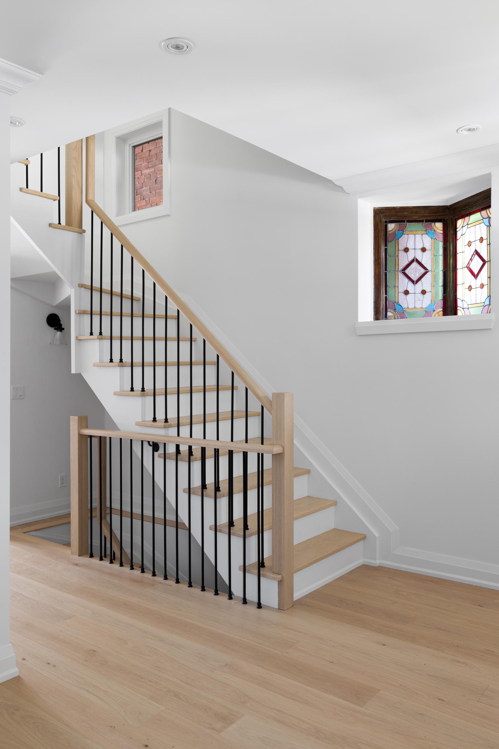 This contemporary staircase provides views of original stained glass windows, that were kept as a nod to the former design of the house.