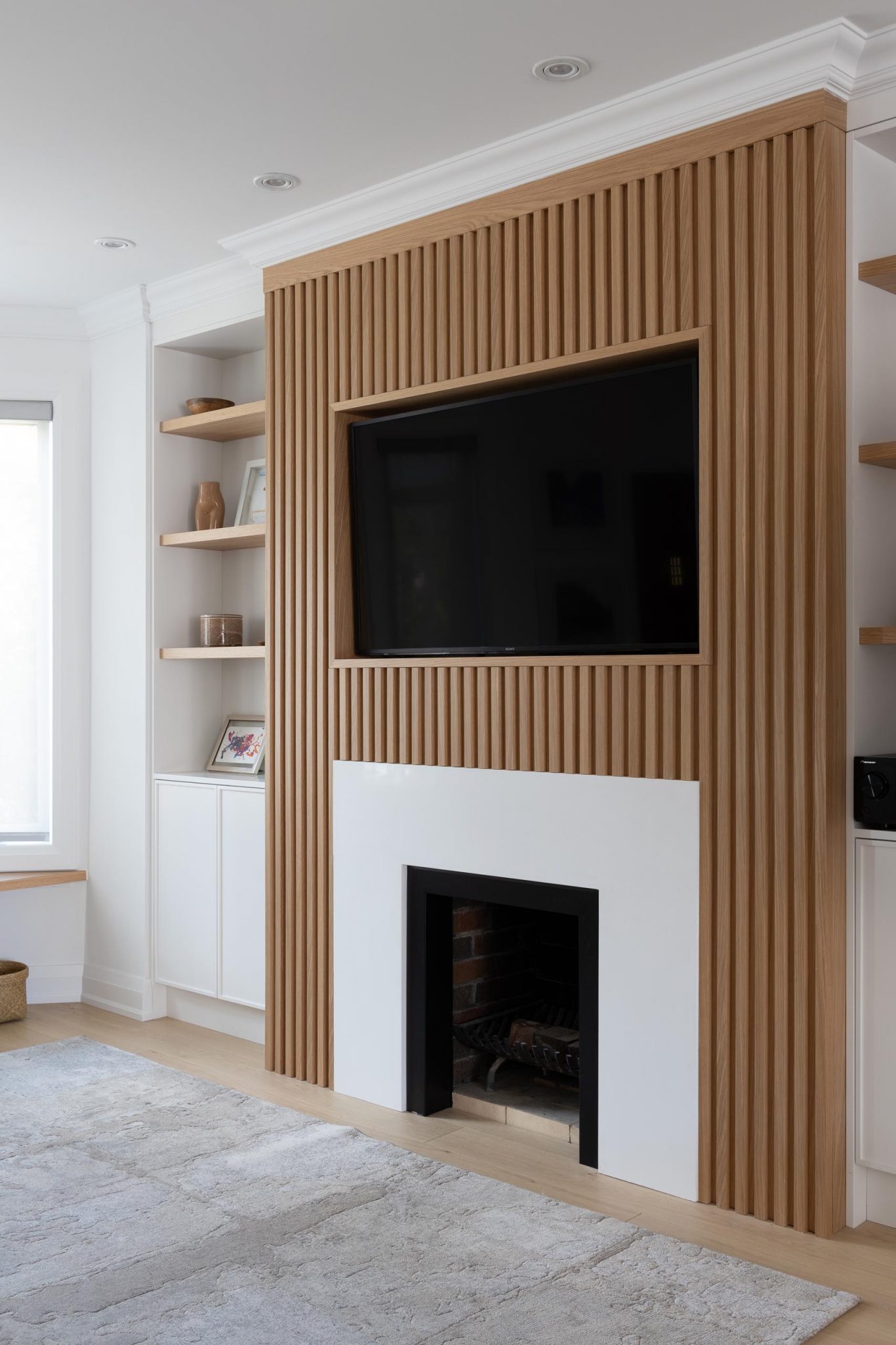 The Wood Slat Accent Of This Living Room Wall Is Perfectly Designed To Surround The TV And Fireplace