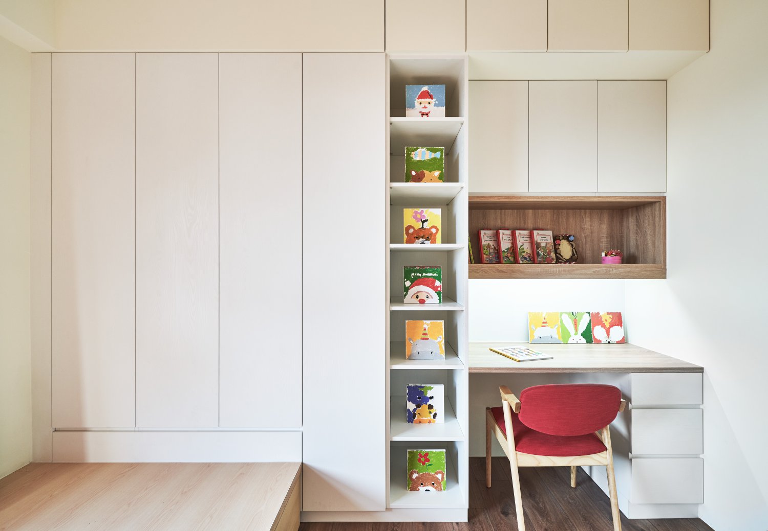 A simple bedroom with minimalist closets and a built-in desk area.