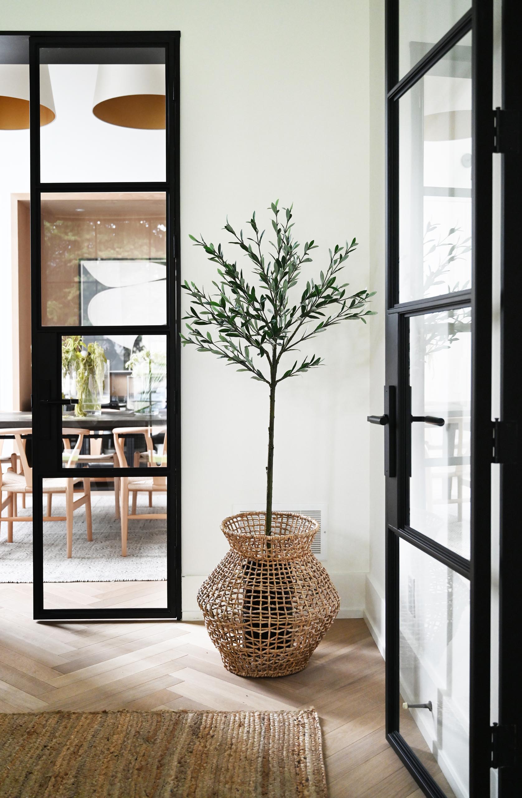 Connecting various areas of the interior are black-framed glass doors that provide a glimpse of the other rooms.