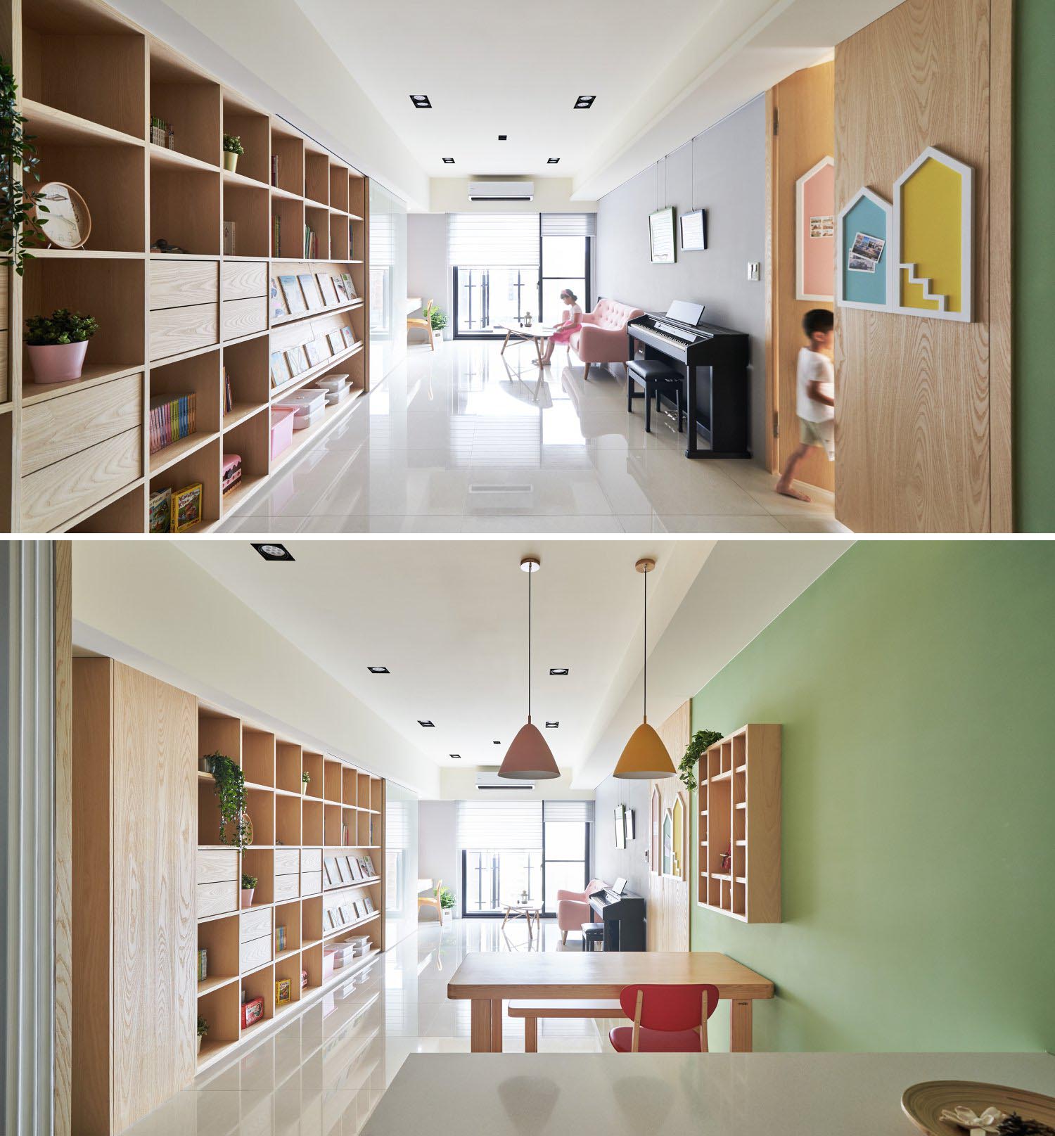 A modern shelving unit with open storage, drawers, book displays, whiteboard walls, and a hidden tv.