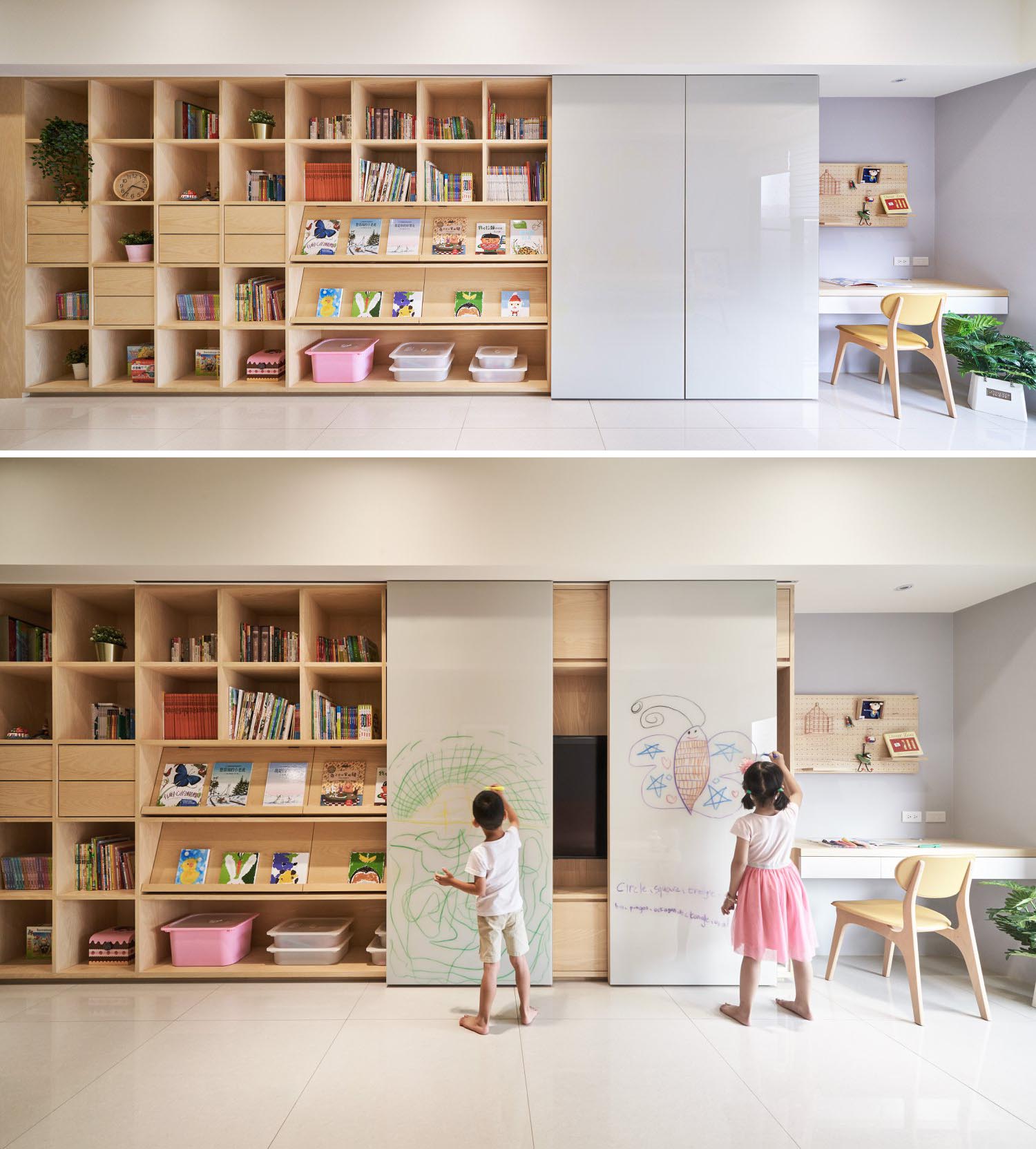 A modern shelving unit with open storage, drawers, book displays, whiteboard walls, and a hidden tv.