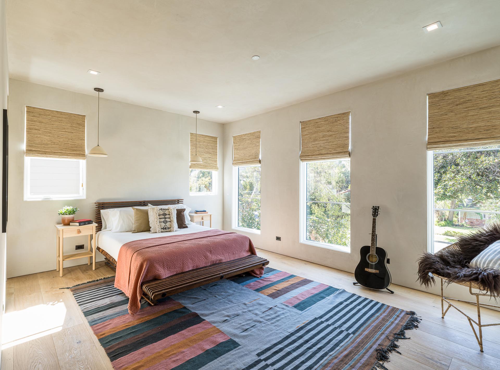 A contemporary guest bedroom with white oak floors.