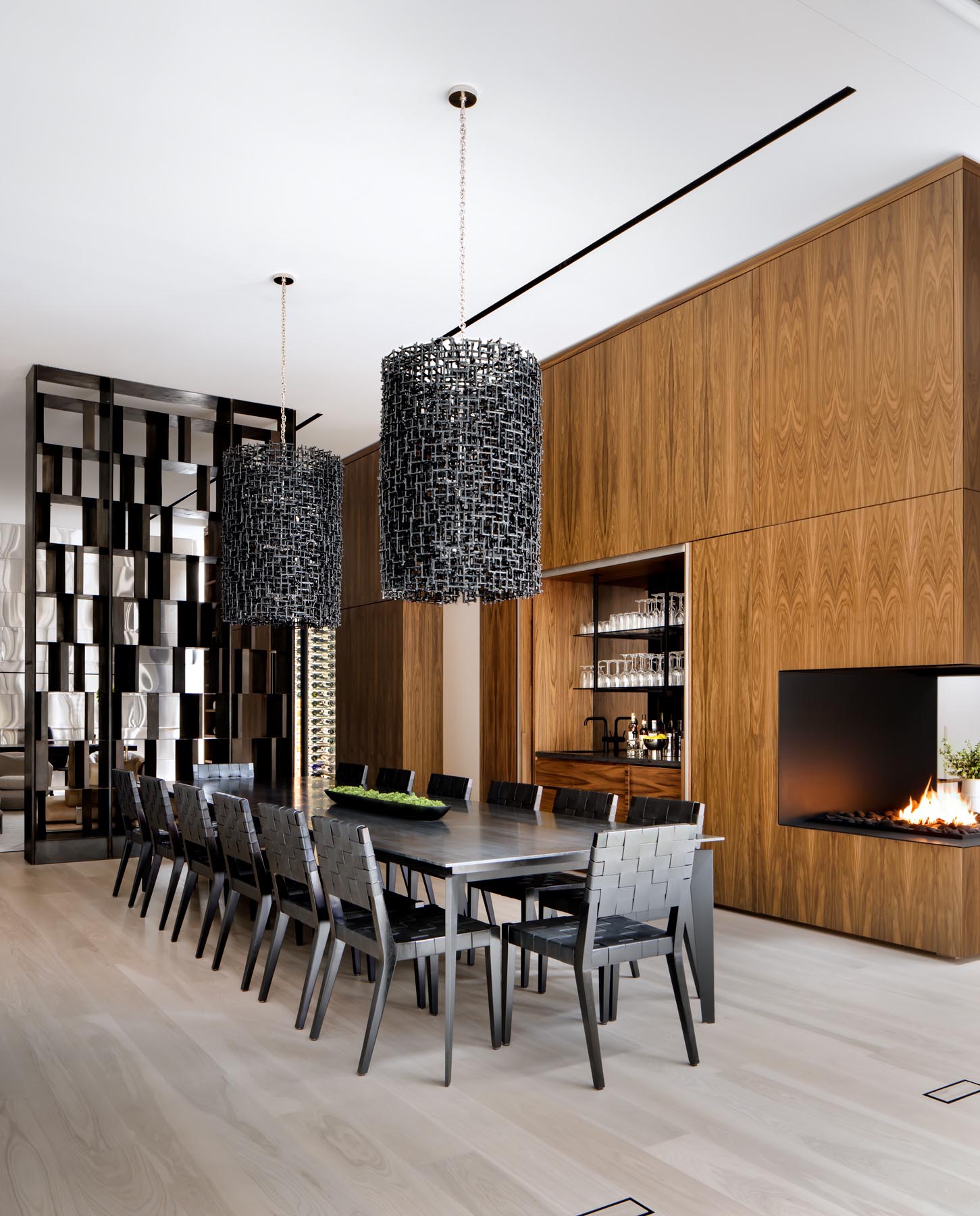 A large shelving unit separates the dining room from the Scotch lounge, while a set of bi-fold doors open to reveal a wet bar.