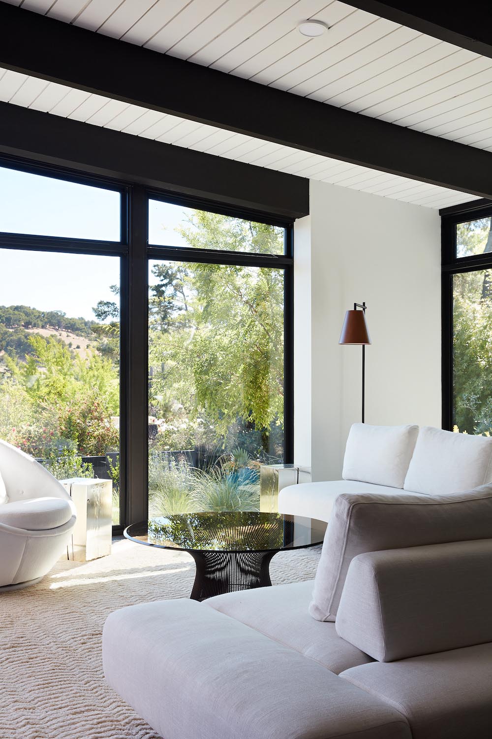 A remodeled living room with a Malm fireplace, black accents, and white walls.