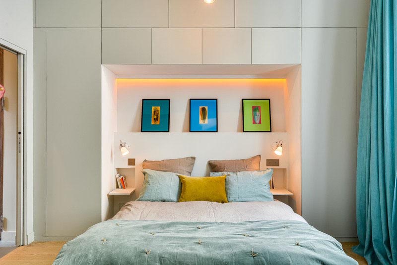 A modern bedroom with built-in cabinetry and hidden LED lighting.
