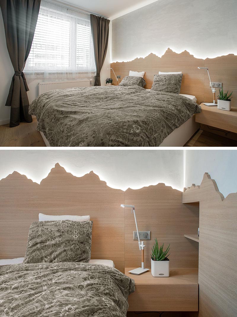 Bedroom Lighting Ideas - A modern white bedroom with a wood mountain-inspired headboard that showcases hidden LED lighting.