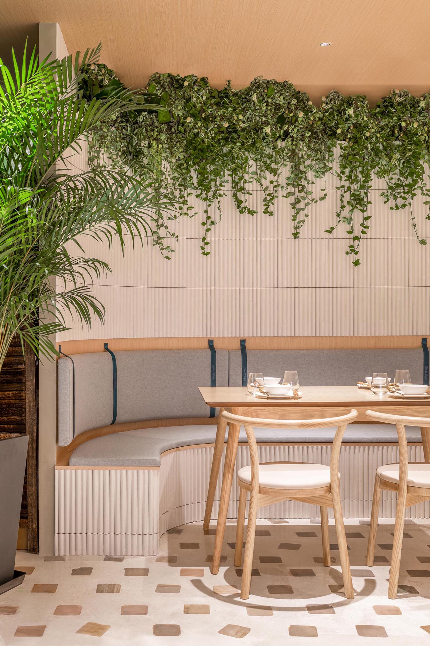 The nooks and sitting areas of this modern cafe appear to have been carved out of the rammed earth that envelops the facade.