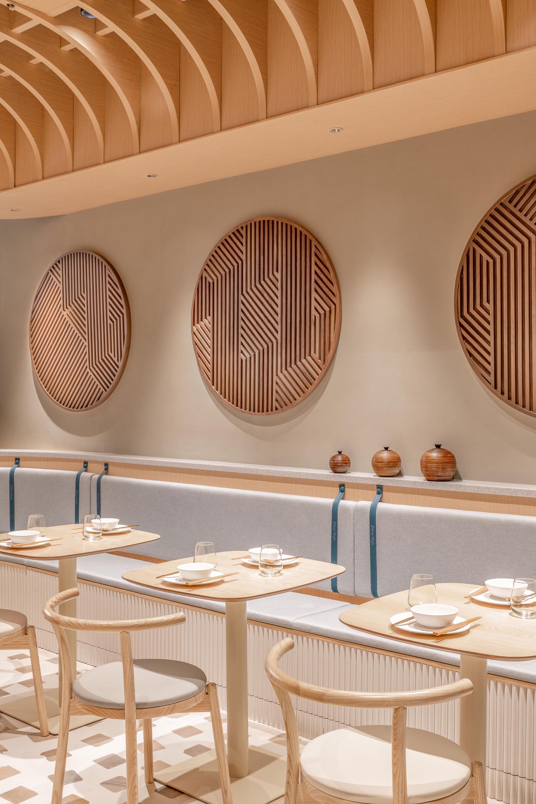 The nooks and sitting areas of this modern cafe appear to have been carved out of the rammed earth that envelops the facade.