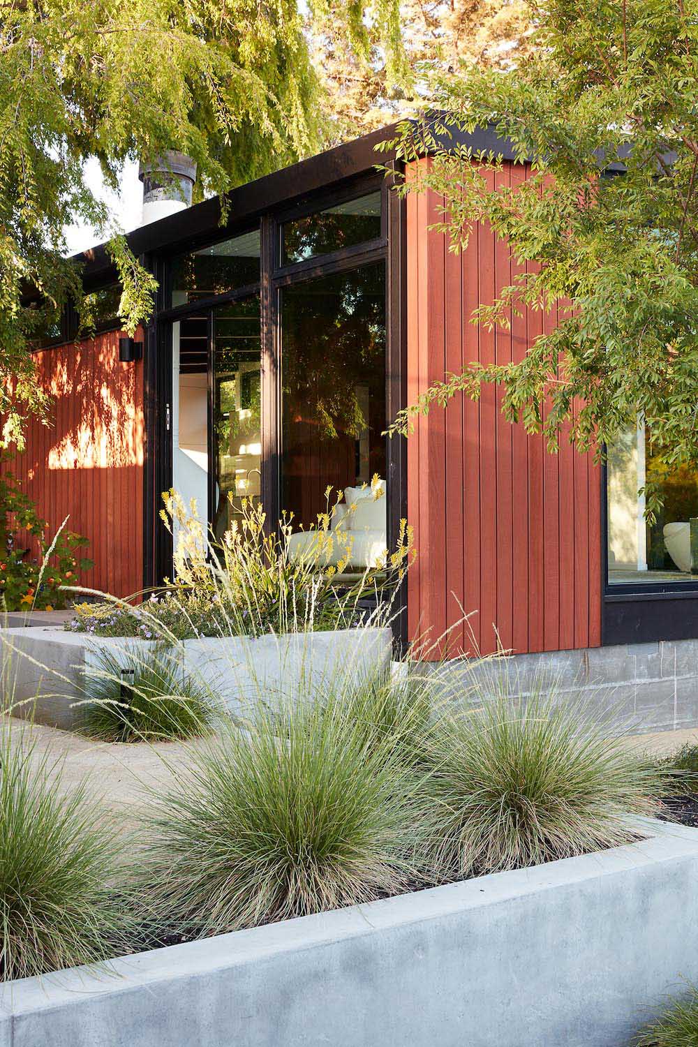 A remodeled mid-century modern house with a mix of relaxing outdoor patio spaces that blend into the native landscaping.