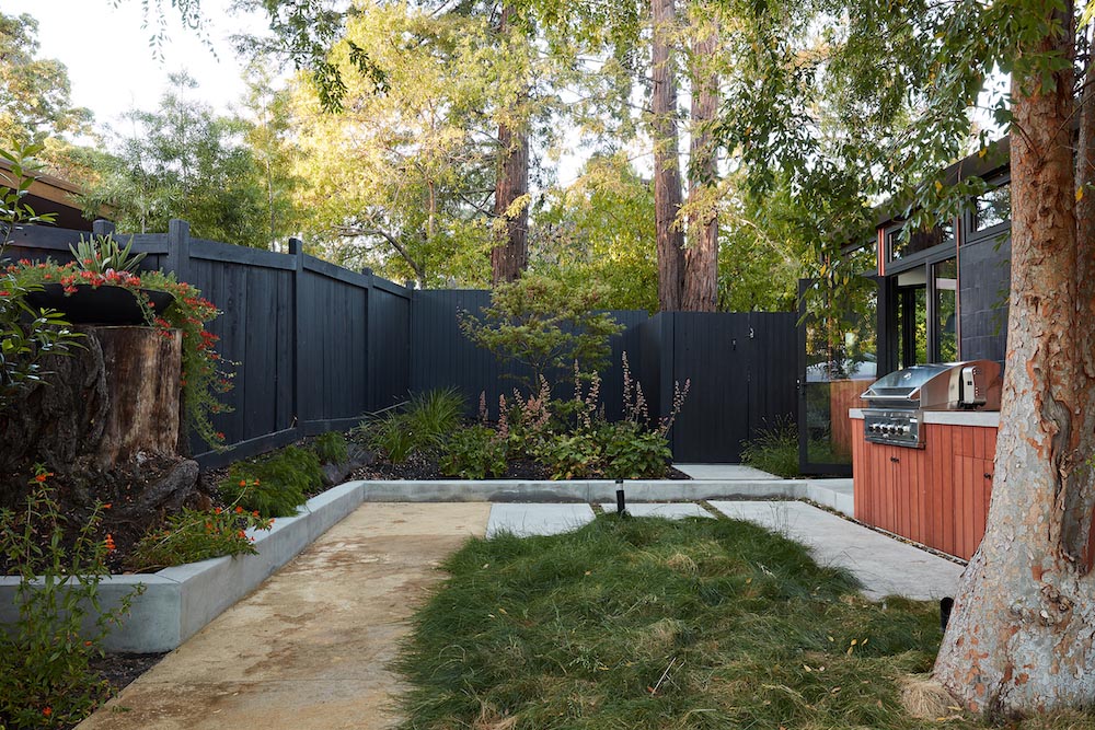 A remodeled mid-century modern house with a mix of relaxing outdoor patio spaces that blend into the native landscaping.