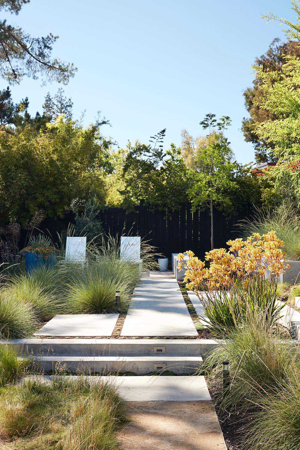 A remodeled mid-century modern house with a mix of relaxing outdoor patio spaces that blend into the native landscaping.