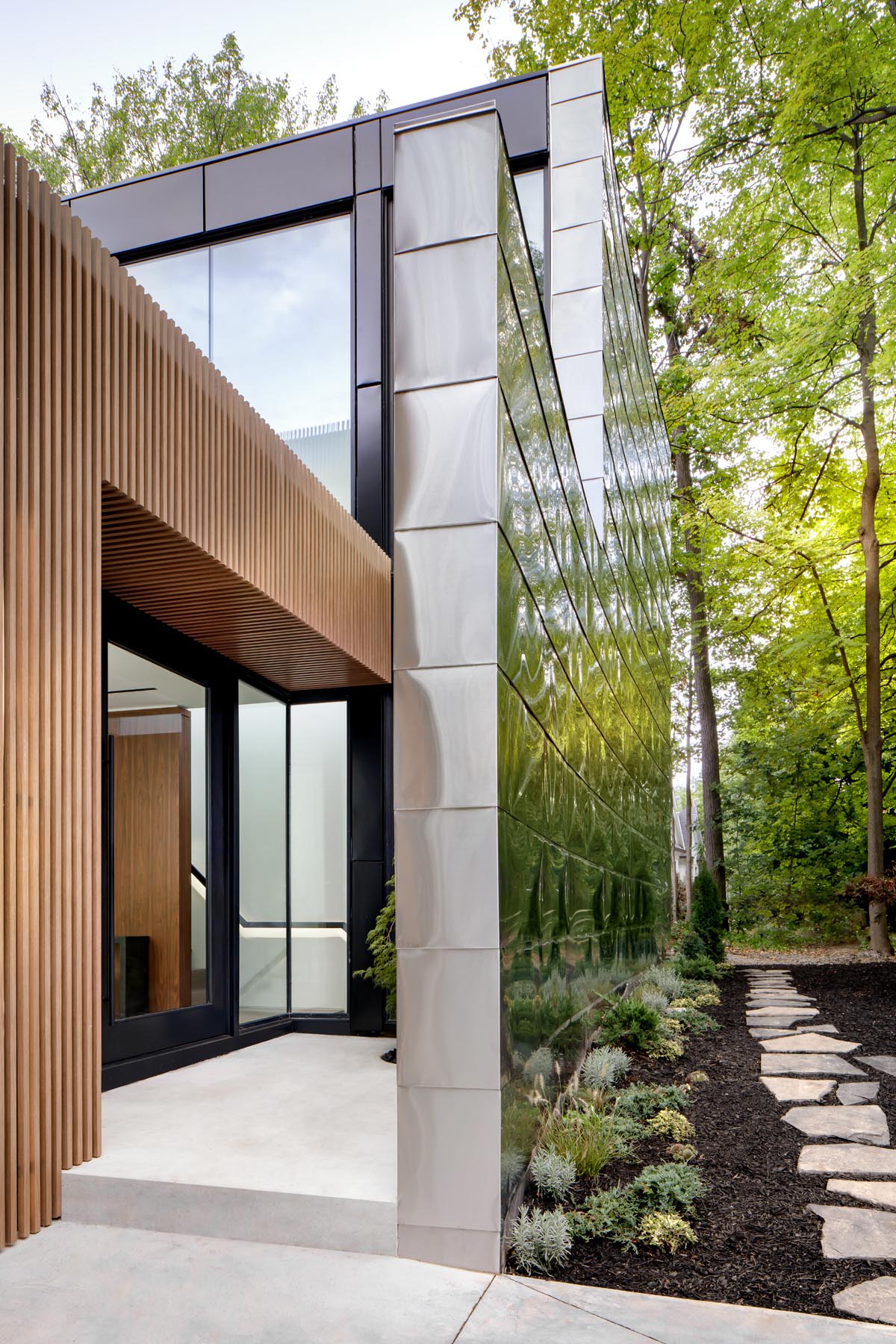The design of this modern house includes a solid front facade, with a tucked away entryway, that afforded the client the privacy they desired.