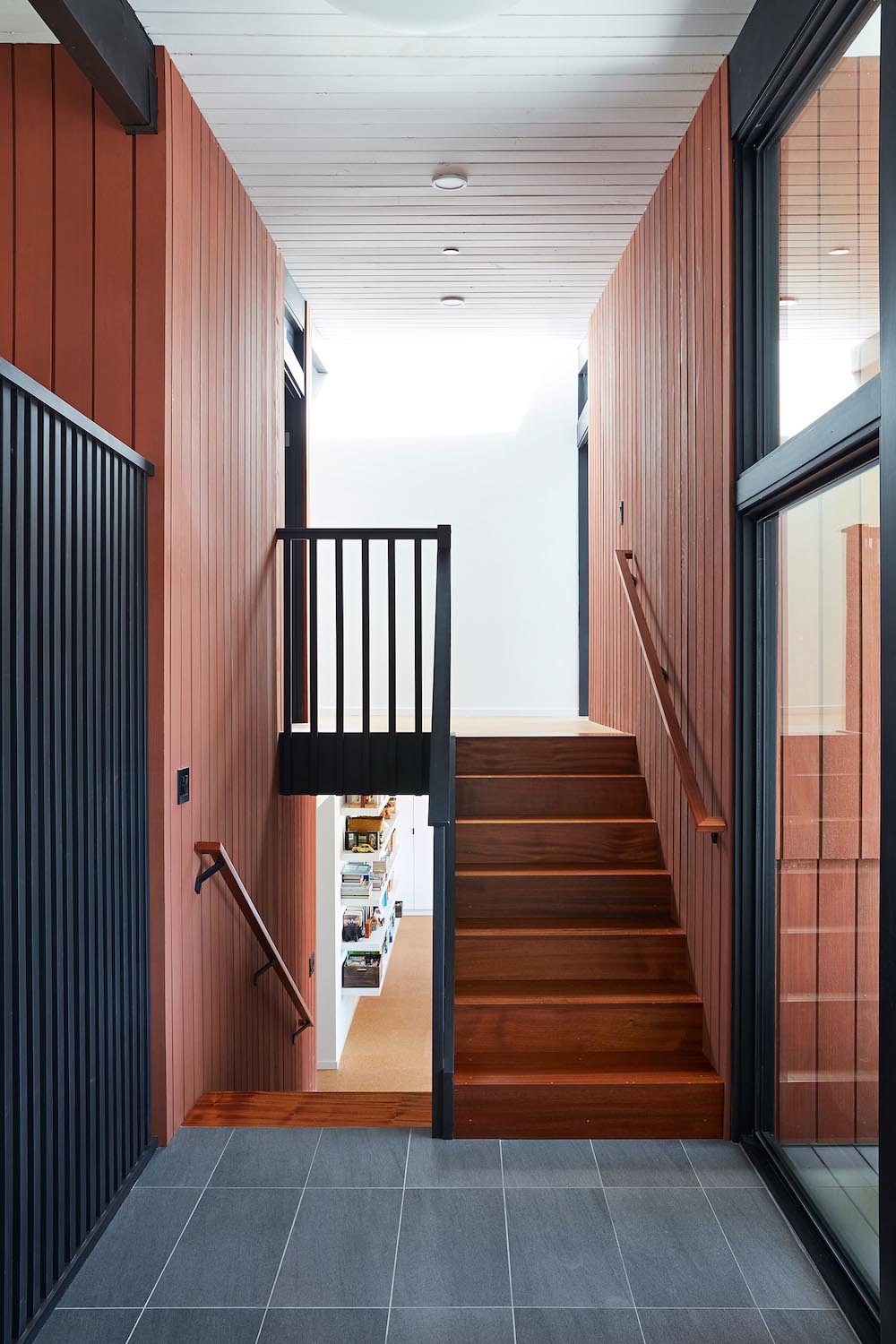 Wood stairs connect the various levels of this remodeled home.