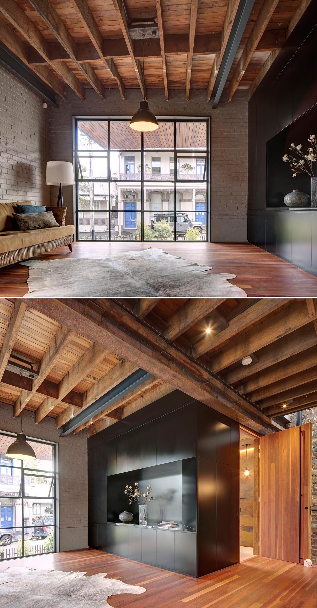 This modern living room looks out onto the street through black-framed windows, and embraces the old and new structural elements instead of hiding them.