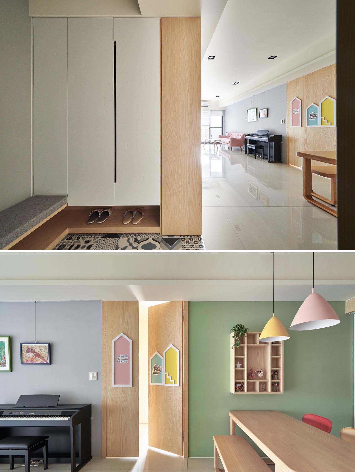 A wood door decorated with white-framed colorful houses that act as wall art and a place to pin photos and drawings.